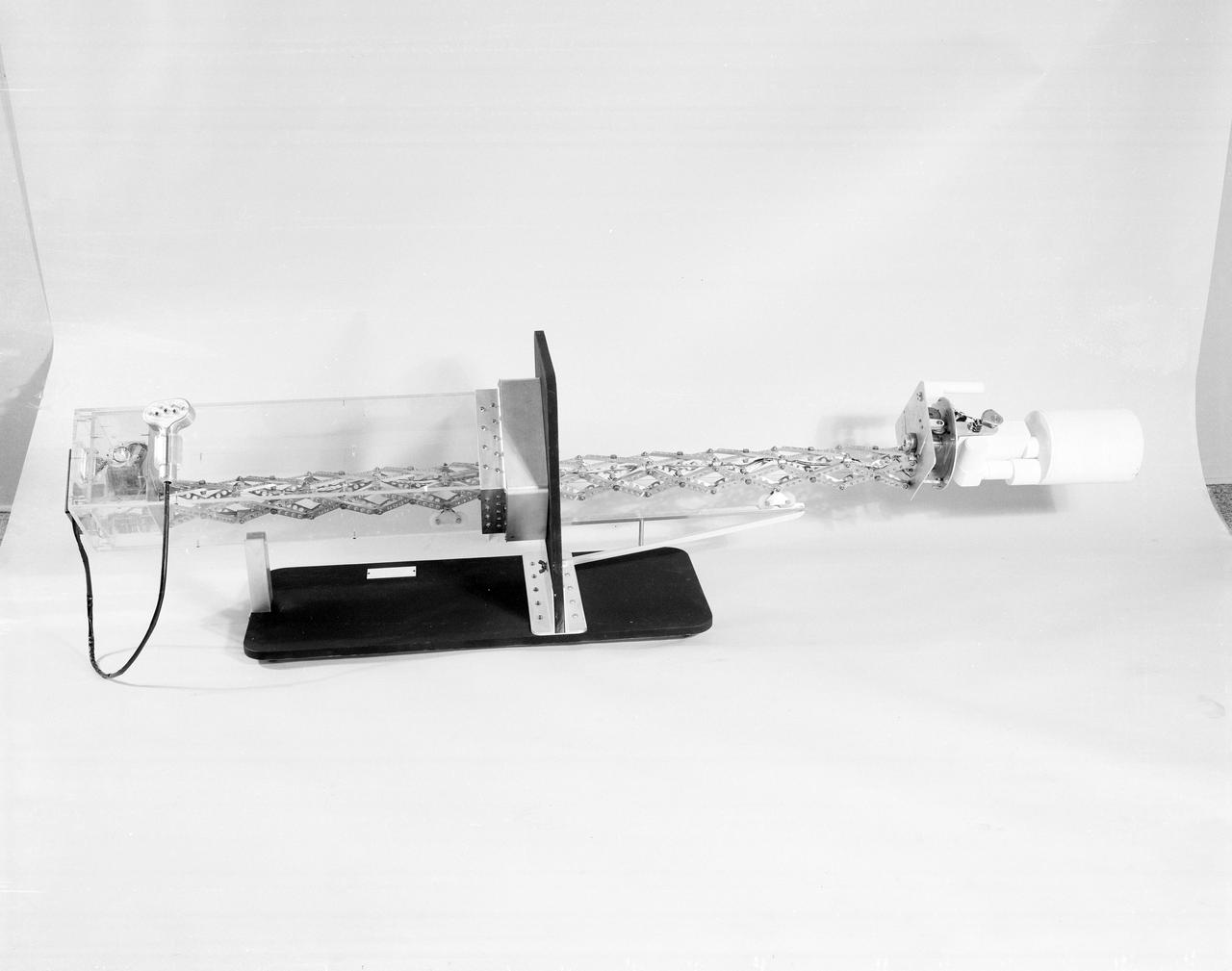 The Apollo Telescope Mount (ATM), designed and developed by the Marshall Space Flight Center, served as the primary scientific instrument unit aboard the Skylab. The ATM contained eight complex astronomical instruments designed to observe the Sun over a wide spectrum from visible light to x-rays. This photo depicts a side view is of a fully extended ATM contamination monitor mockup.