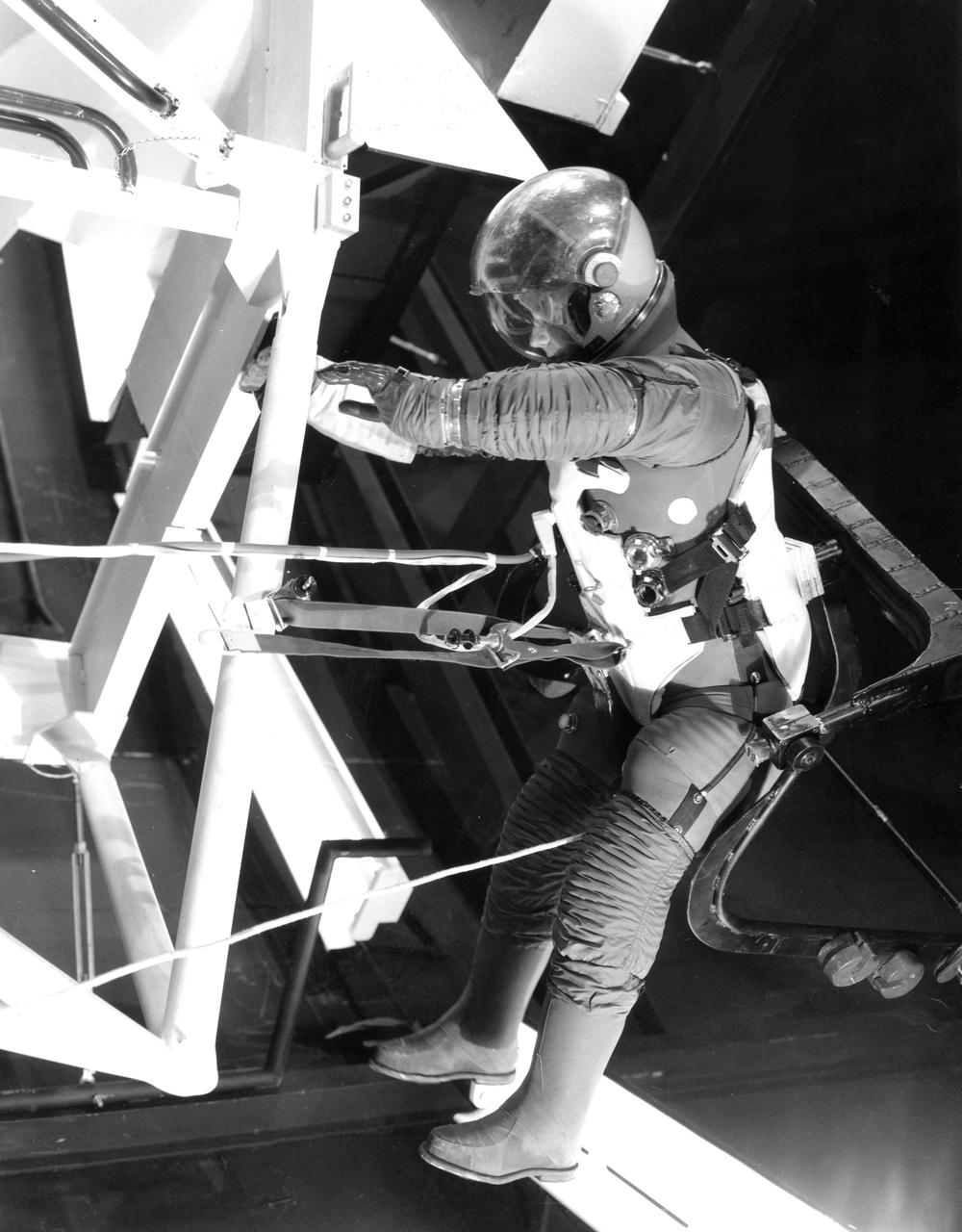 An astronaut wearing a pressurized space suit performed a work task while suspended in a “zero-gravity” simulator known as the Neutral Buoyancy Simulator (NBS) at Marshall Space Flight Center. This particular task was one of many performed by astronauts while checking out the mockup for the Apollo Telescope Mount.
