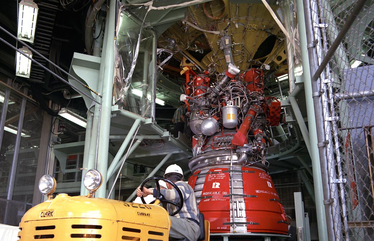Workmen secure a J-2 engine onto the S-IVB (second) stage thrust structure. As part of Marshall Space Center's "building block" approach to the Saturn development, the S-IVB was utilized in the Saturn IBC launch vehicle as a second stage and the Saturn V launch vehicle as a third stage. The booster, built for NASA by McDornell Douglas Corporation, was powered by a single J-2 engine, initially capable of 200,000 pounds of thrust.