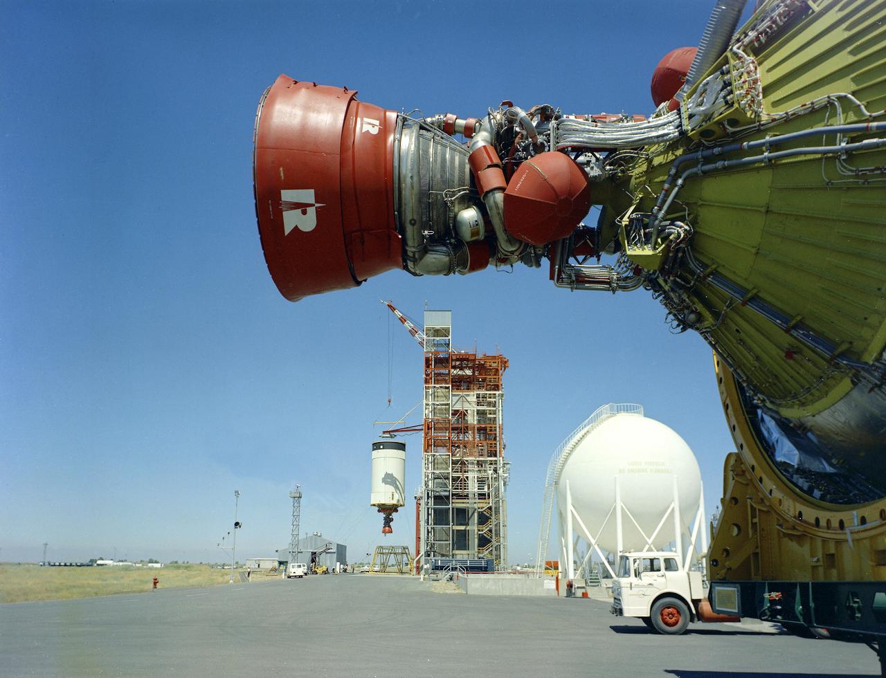This is a view of the Saturn V S-IVB (third) stage for the AS-209 (Apollo-Soyuz test project backup vehicle) on a transporter in the right foreground, and the S-IVB stage for AS-504 (Apollo 9 mission) being installed in the Beta Test Stand 1 at the SACTO facility in California. After the S-II (second) stage dropped away, the S-IVB (third) stage ignited and burned for about two minutes to place itself and the Apollo spacecraft into the desired Earth orbit. At the proper time during this Earth parking orbit, the S-IVB stage was re-ignited to speed the Apollo spacecraft to escape velocity and inject it and the astronauts into a moon trajectory. Developed and manufactured by the Douglas Aircraft Company in California, the S-IVB stage measures about 21.5 feet in diameter, about 58 feet in length, and is powered by a single 200,000-pound-thrust J-2 engine with a re-start capability. The S-IVB stage was also used on the second stage of the Saturn IB launch vehicle.