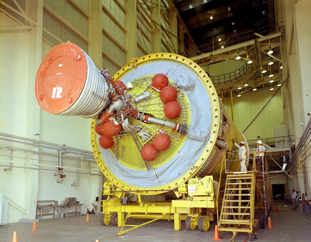 After the S-II (second) stage dropped away, the S-IVB (third) stage ignited and burned for about two minutes to place itself and the Apollo spacecraft into the desired Earth orbit. At the proper time during this Earth parking orbit, the S-IVB stage was re-ignited to speed the Apollo spacecraft to escape velocity, injecting it and the astronauts into a moon trajectory. Developed and manufactured by the Douglas Aircraft Company in Huntington, California, the S-IVB stage measures about 21.5 feet in diameter, about 58 feet in length and is powered by a single 200,000-pound-thrust J-2 engine with a re-start capability. The S-IVB stage was also used on the second stage of the Saturn IB launch vehicle. The fully-assembled S-IVB (third) stage for the AS-503 (Apollo 8 mission) launch vehicle is pictured in the Douglas' vertical checkout building.