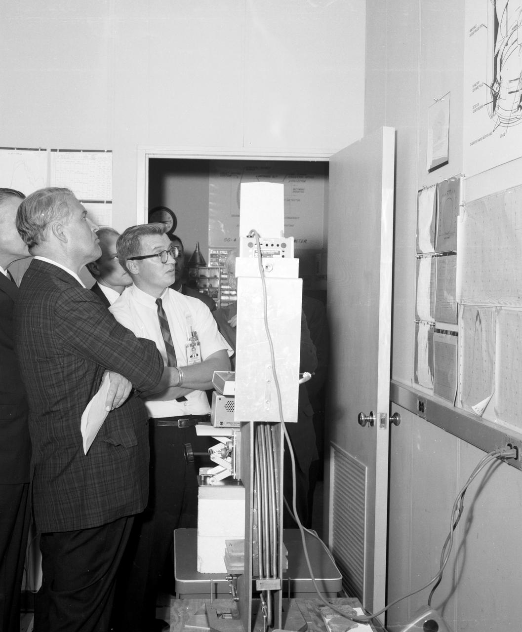 Marshall Space Flight Center’s (MSFC) Director, Dr. Wernher von Braun (left), studies charts depicting the status of an experiment conducted in MSFC’s Space Sciences Laboratory during a tour on August 28, 1967.