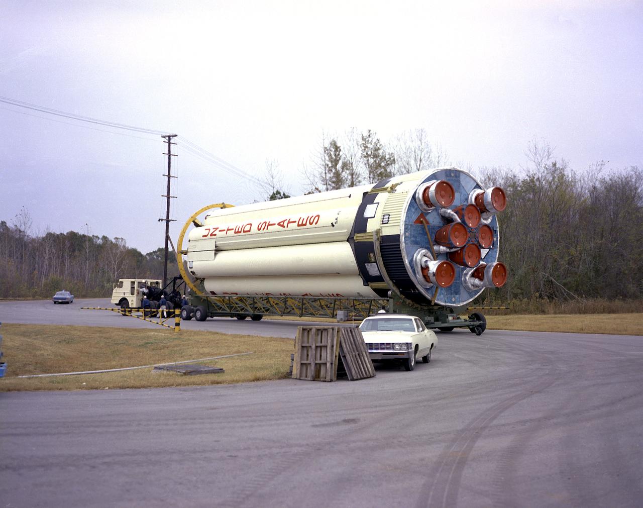 S-IB-211, the flight version of the Saturn IB launch vehicle's first (S-IVB) stage, on its way to Marshall Space Flight Center's (MSFC's) west test area. Between December 1967 and April 1968, the stage would undergo seven static test firings. The S-IB, developed by the MSFC and built by the Chrysler Corporation at the Michoud Assembly Facility near New Orleans, Louisiana, utilized eight H-1 engines and each produced 200,000 pounds of thrust. 