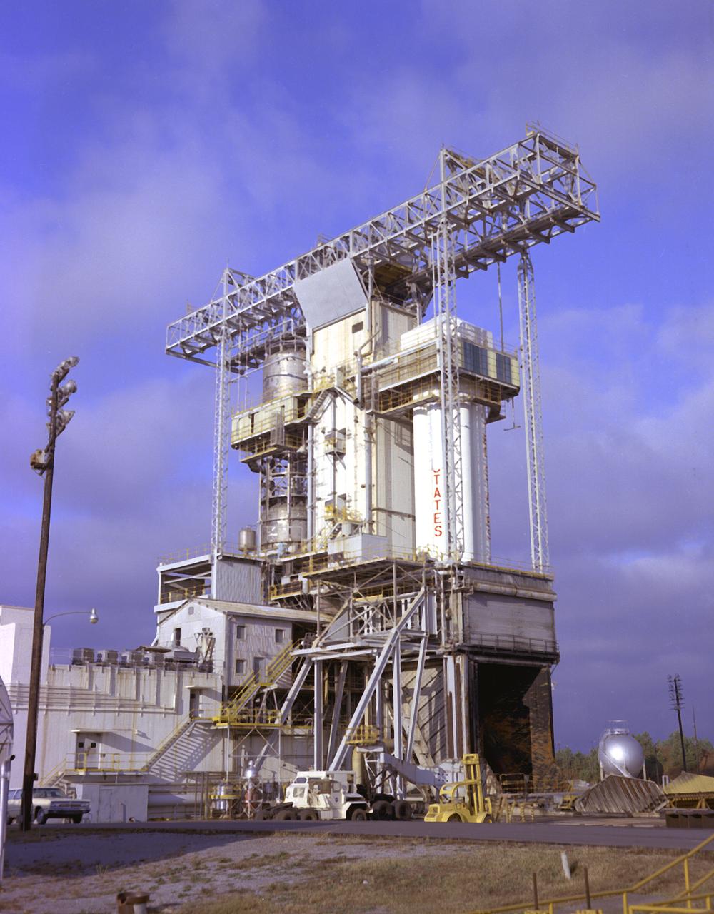 S-IB-211, the flight version of the Saturn IB launch vehicle's (S-IVB) first stage, after installation at the Marshall Space Flight Center's (MSFC's) S-IB static test stand. Between December 1967 and April 1968, the stage would undergo seven static test firings. The S-IB, developed by the MSFC and built by the Chrysler Corporation at the Michoud Assembly Facility near New Orleans, Louisiana, utilized eight H-1 engines and each produced 200,000 pounds of thrust. 