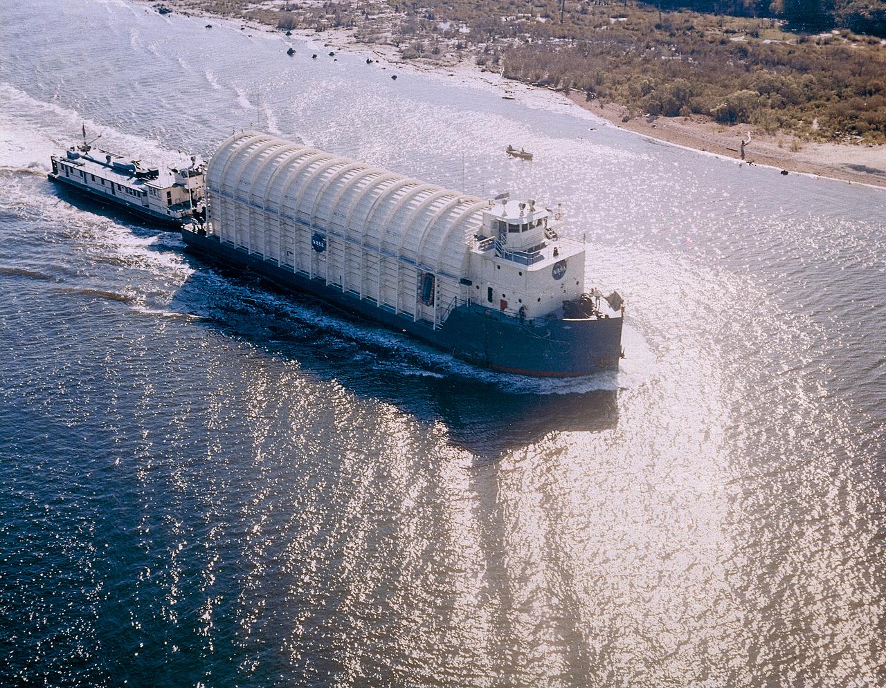 NASA used barges for transporting full-sized stages for the Saturn I, Saturn IB, and Saturn V vehicles between the Marshall Space Flight Center (MSFC), the manufacturing plant at the Michoud Assembly Facility (MAF), the Mississippi Test Facility for testing, and the Kennedy Space Center. The barges traveled from the MSFC dock to the MAF, a total of 1,086.7 miles up the Tennessee River and down the Mississippi River. The barges also transported the assembled stages of the Saturn vehicle from the MAF to the Kennedy Space Center, a total of 932.4 miles along the Gulf of Mexico and up along the Atlantic Ocean, for the final assembly and the launch. Pictured is the barge Palaemon carrying Saturn IV S-IB flight stage enroute to MSFC.
