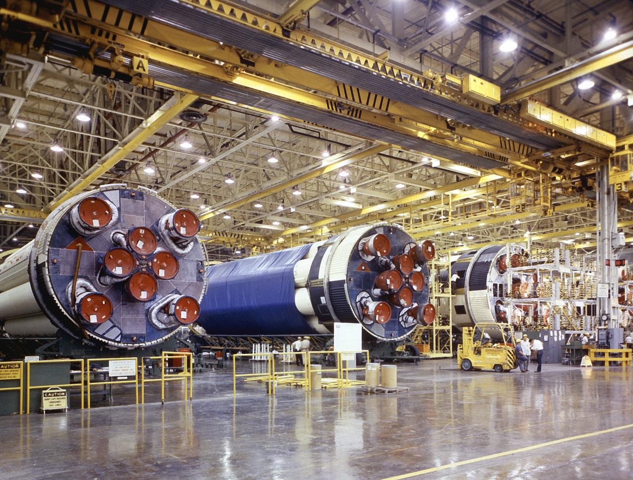 Three S-IB stages near completion at the NASA's Michoud Assembly Facility (MAF) near New Orleans, Louisiana, in November 1967. Developed by the Marshall Space Flight Center and built by the Chrysler Corporation at MAF, the 90,000-pound booster utilized eight H-1 engines and each produced 200,000 pounds of thrust for the Saturn IB launch vehicle's first stage. 
