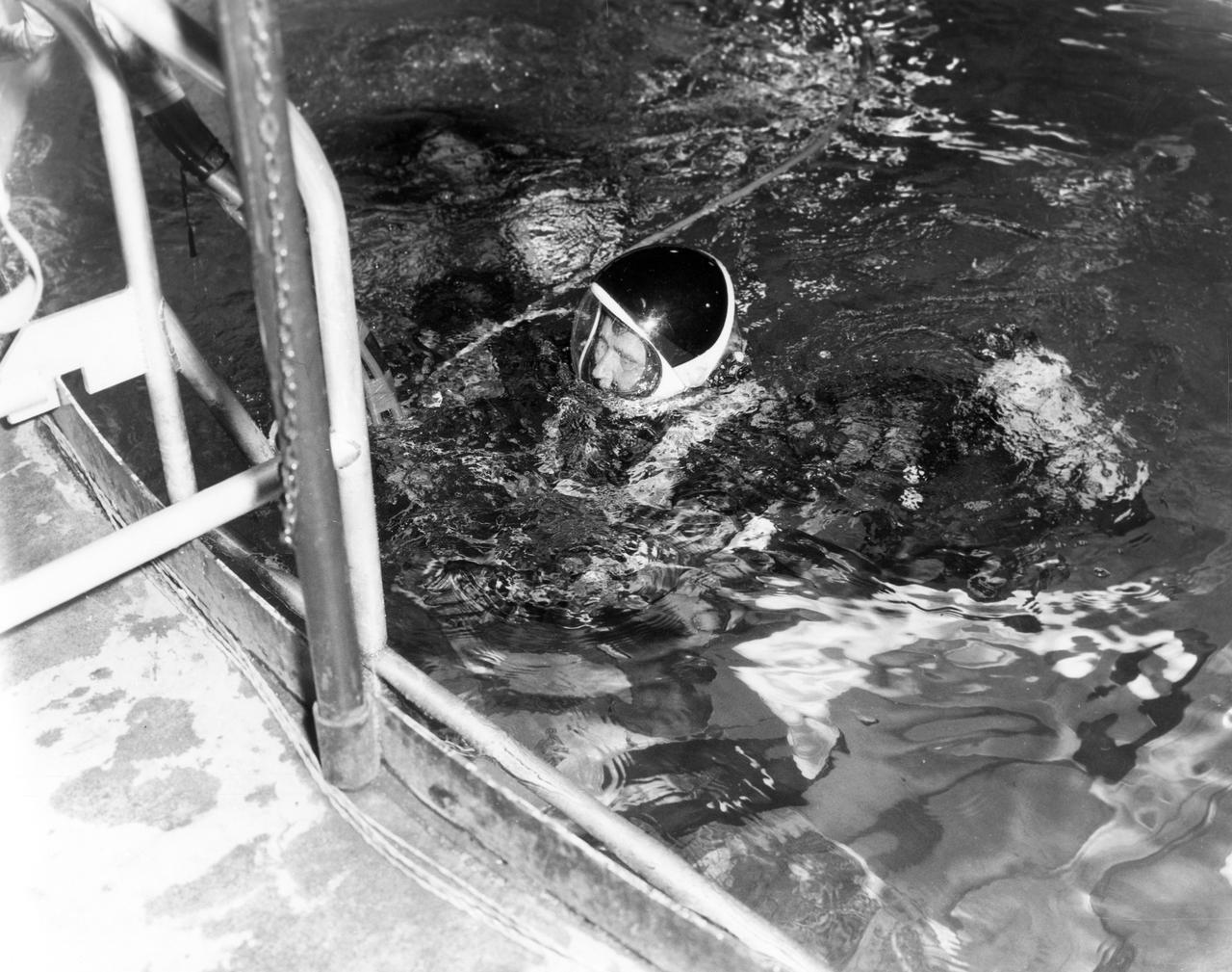 Marshall Space Flight Center (MSFC) Director, Dr. von Braun, submerges after spending some time under water in the MSFC Neutral Buoyancy Simulator (NBS). Weighted to a neutrally buoyant condition, Dr. von Braun was able to perform tasks underwater which simulated weightless conditions found in space.