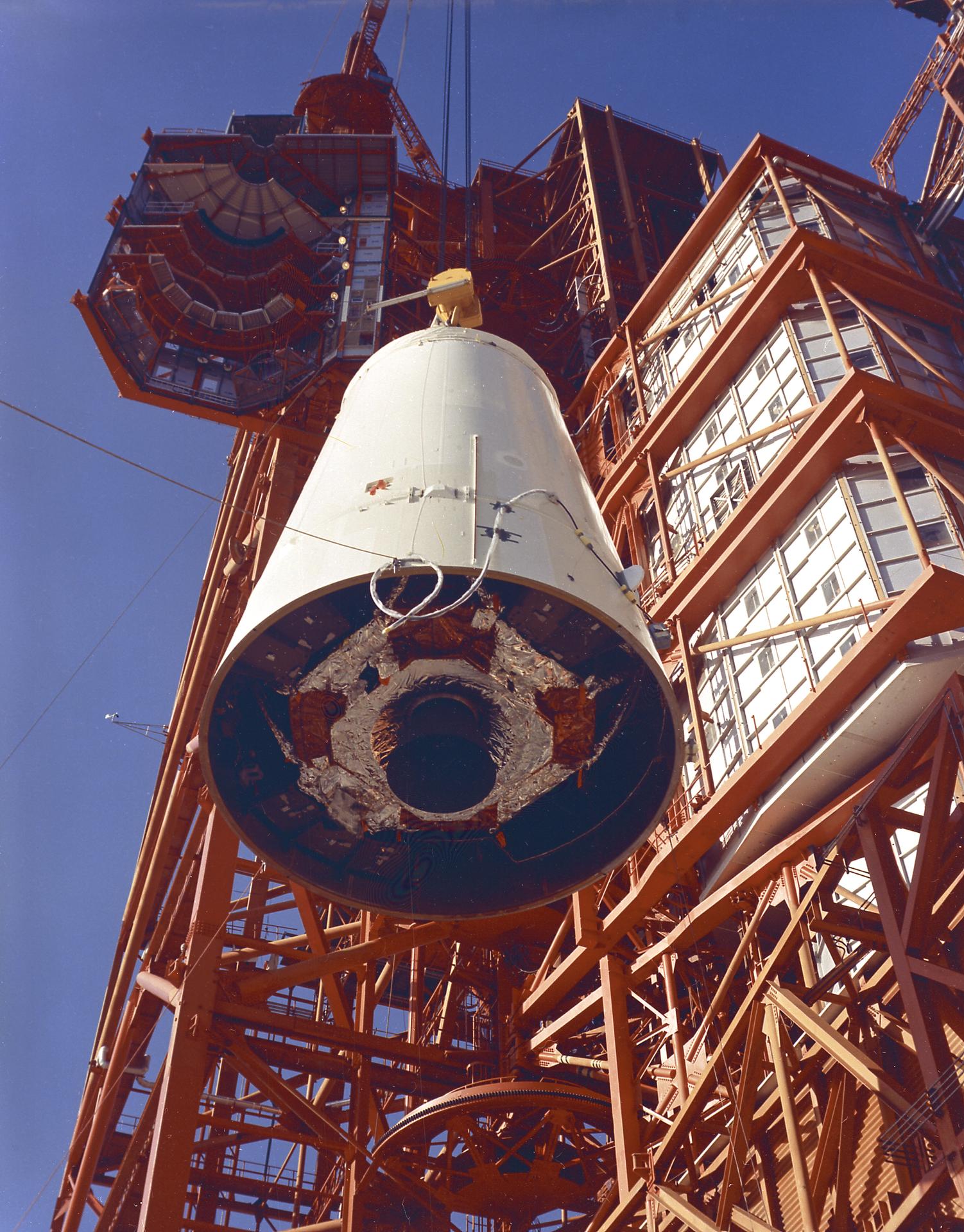 The Saturn Lunar Module adapter is hoisted into position