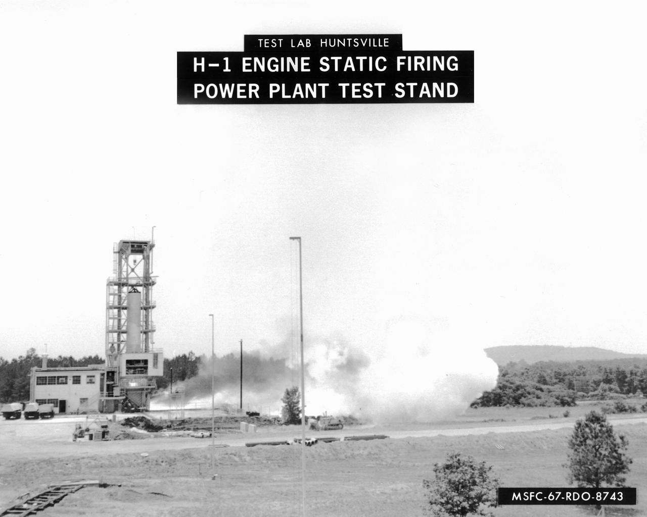 This image depicts a firing of a single H-1 engine at the Marshall Space Flight Center’s (MSFC’s) Power Plant test stand. This 1950s test stand, inherited from the Army, was used to test fire engines until the Test Area was completed in the latter 1960s. The H-1 engine was the workhorse of the first Saturn launch vehicles and used in the Saturn I, Block 1 and II, and in the Saturn IB. The eight H-1 engines were attached to a thrust frame on the vehicle’s aft end in two different ways. Four engines are rigidly attached to the inboard position and canted at a three degree angle to the long axis of the booster. The other four engines, mounted in the outboard position, are canted at six degrees.