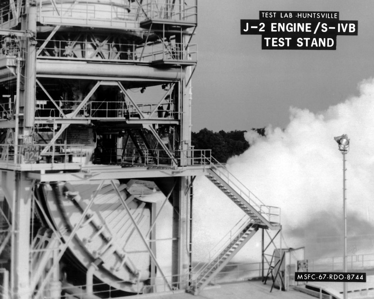 This image depicts the test firing of a J-2 engine in the S-IVB Test Stand at the Marshall Space Flight Center (MSFC).  The J-2, developed by Rocketdyne under the direction of MSFC, was propelled by liquid hydrogen and liquid oxygen.  A single J-2 was utilized in the S-IVB stage (the second stage for the Saturn IB and third stage for the Saturn V) and in a cluster of five for the second stage (S-II) of the Saturn V.  Initially rated at 200,000 pounds of thrust, the engine was later upgraded in the Saturn V program to 230,000 pounds.