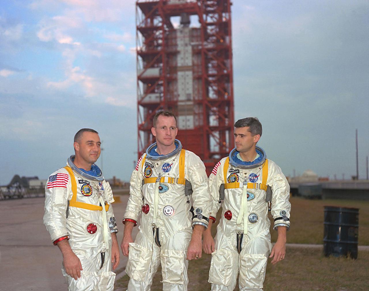KENNEDY SPACE CENTER, FLA. -- Astronauts, left to right, Gus Grissom, Ed White, and Roger Chaffee, pose in front of Launch Complex 34 which is housing their Saturn 1 launch vehicle.  The astronauts are scheduled for the Apollo Saturn 204 (Apollo 1) mission.