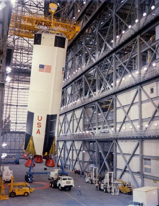 Teams lift the first stage of the Apollo 8 Saturn V rocket inside the transfer aisle of the Vehicle Assembly Building at NASA’s Kennedy Space Center in Florida on Feb. 1, 1968, and prepare to place it atop the mobile launcher. Apollo 8 was the first crewed spacecraft to successfully orbit the Moon and return to Earth, setting the stage for Apollo 11 – the first crewed lunar landing. Apollo 8 launched on Dec. 21, 1968, and the crew members consisted of Frank Borman, William A. Anders, and James A. Lovell Jr.