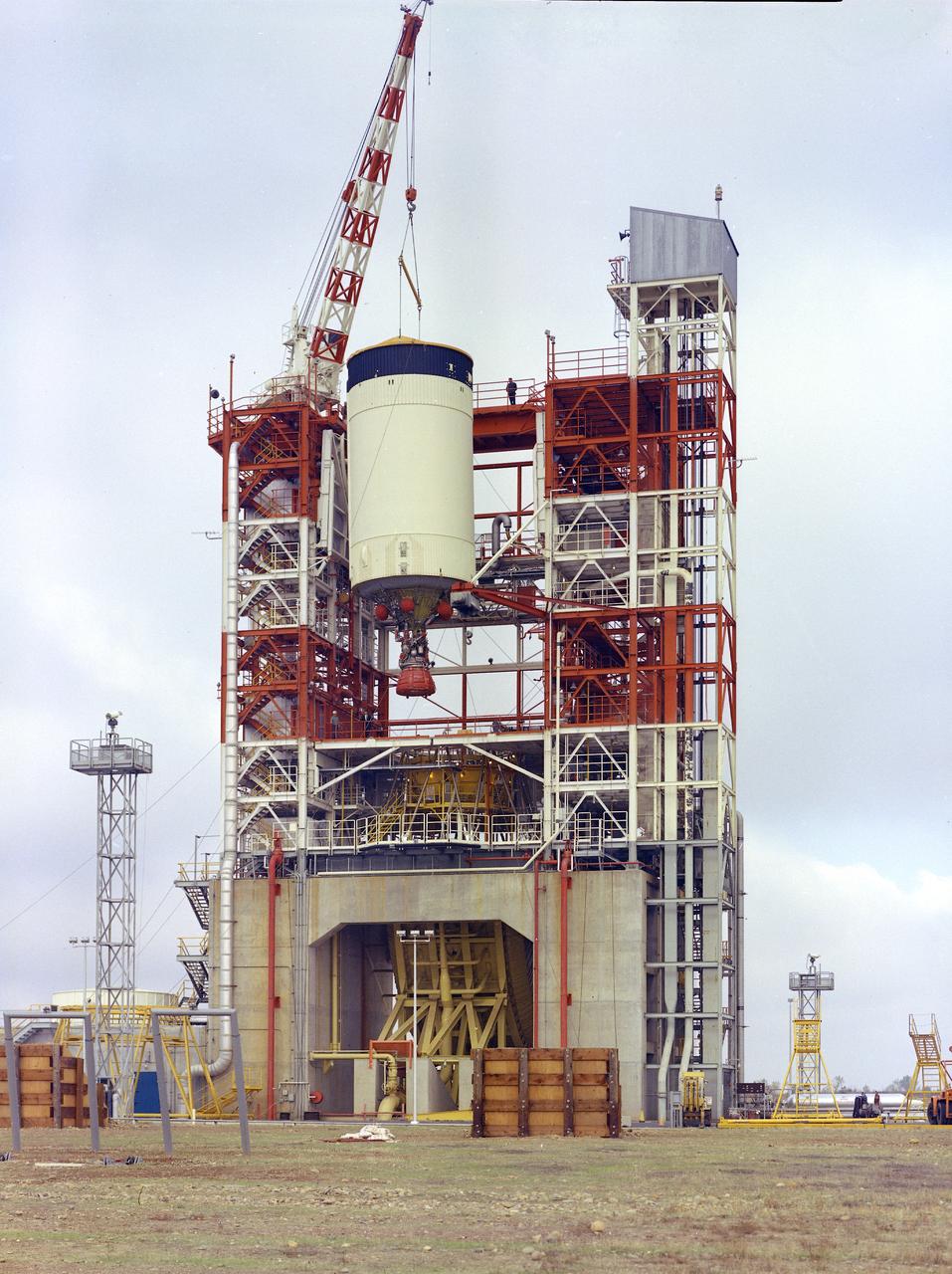 This image depicts the Saturn V S-IVB (third) stage for the Apollo 10 mission being removed from the Beta Test Stand 1 after its acceptance test at the Douglas Aircraft Company's Sacramento Test Operations (SACTO) facility. After the S-II (second) stage dropped away, the S-IVB (third) stage was ignited and burned for about two minutes to place itself and the Apollo spacecraft into the desired Earth orbit. At the proper time during this Earth parking orbit, the S-IVB stage was re-ignited to speed the Apollo spacecraft to escape velocity injecting it and the astronauts into a moon trajectory. Developed and manufactured by the Douglas Aircraft Company in California, the S-IVB stage measures about 21.5 feet in diameter, about 58 feet in length, and powered by a single 200,000-pound-thrust J-2 engine with a re-start capability. The S-IVB stage was also used on the second stage of the Saturn IB launch vehicle.