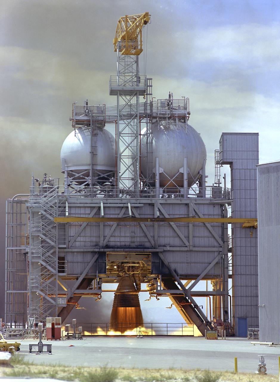 The F-1 engine was developed and built by Rocketdyne under the direction of the Marshall Space Flight Center. It measured 19 feet tall by 12.5 feet at the nozzle exit, and produced a 1,500,000-pound thrust using liquid oxygen and kerosene as the propellant. The image shows an F-1 engine being test fired at the Test Stand 1-C at the Edwards Air Force Base in California. 