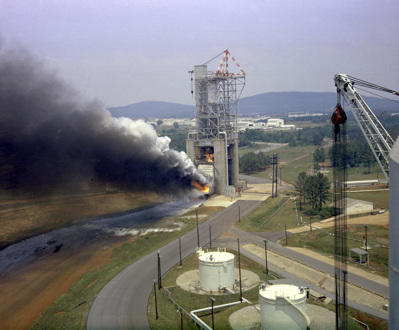 This photograph depicts a test firing of an F-1 engine at the F-1 engine test stand in the west test area of the Marshall Space Flight Center. This engine produced 1,500,000 pounds of thrust using liquid oxygen and RP-1, which is a derivative of kerosene. The F-1 engine test stand was constructed in 1963 to assist in the development of the F-1 engine. 