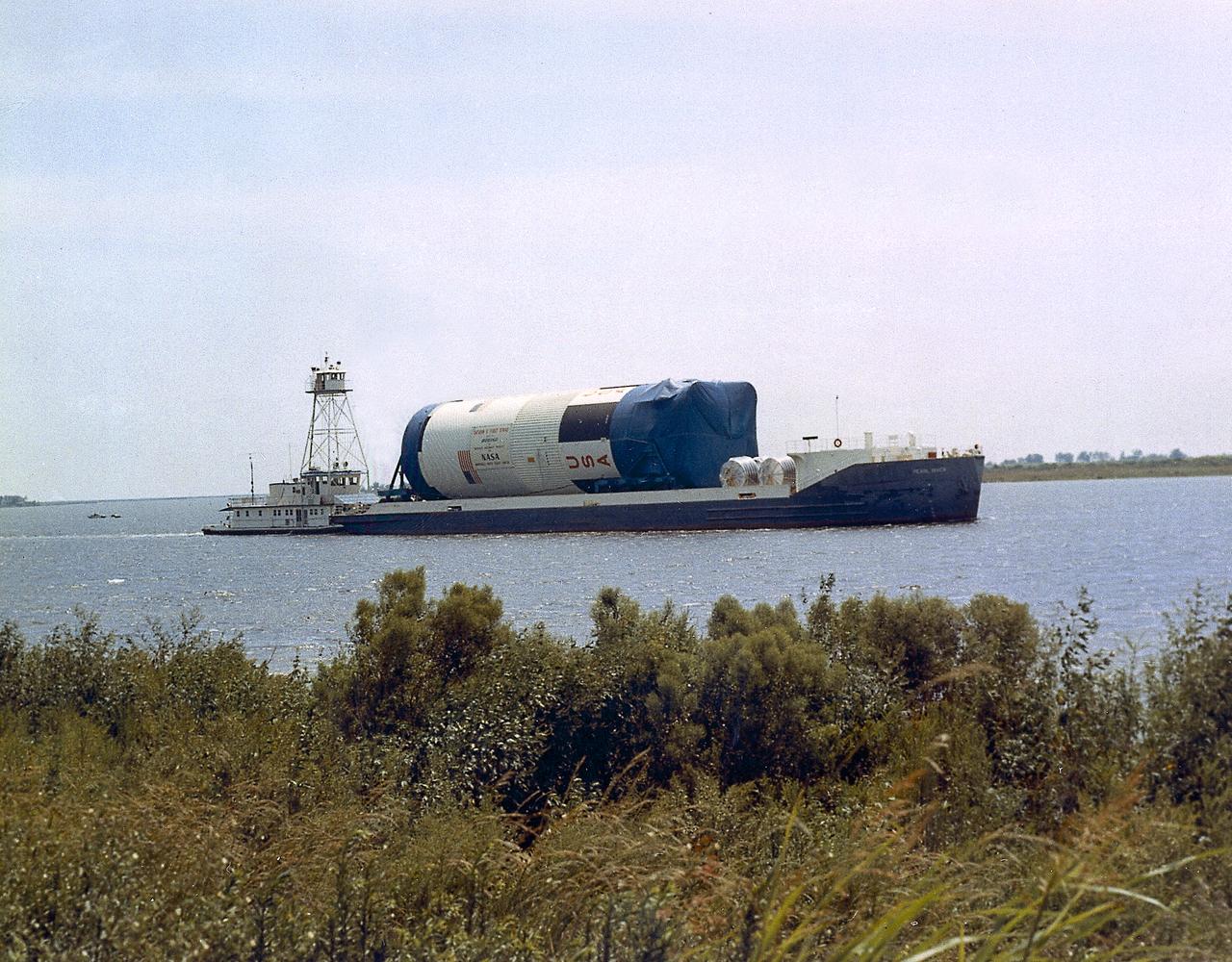 This is a view of the Saturn V S-IC (first) stage aboard the NASA barge, Pearl River, returning from the Mississippi Test Facility to the Michoud Assembly Facility.