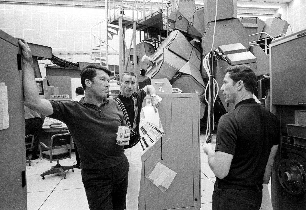 KENNEDY SPACE CENTER, FLA. -- Apollo 7 astronauts, left to right, Walter Schirra, Walter Cunningham and Donn Eisele pause during a practice mission yesterday within Kennedy Space Center's Flight Crew Training Building. The trio spent several hours in the Apollo mission simulator, rear, in preparation for their upcoming mission. The National Aeronautics and Space Administration's first manned Apollo flight is scheduled to begin no earlier than Oct. 11, 1968.
