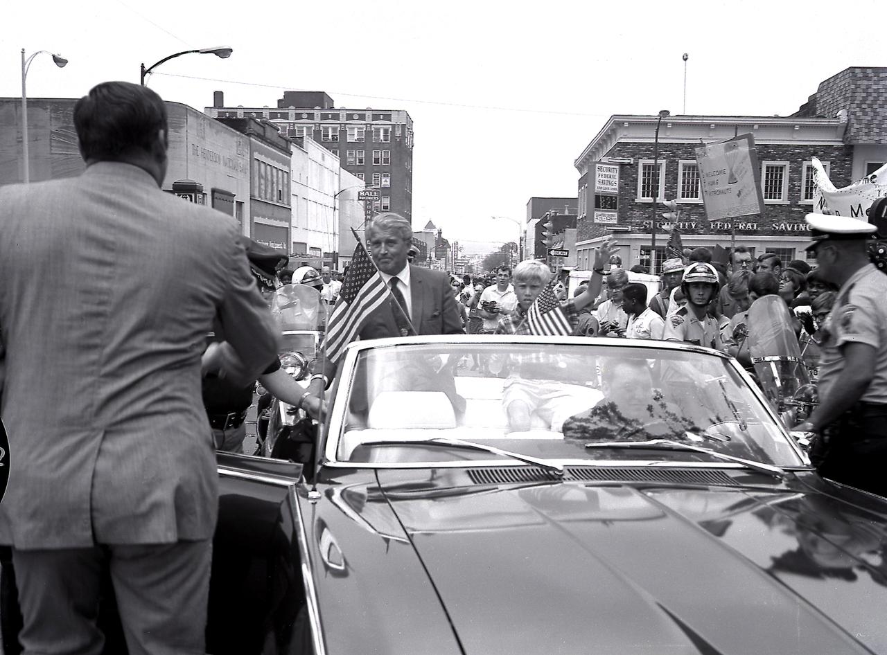 Dr. von Braun and his son were driven around the Courthouse Square during the Apollo 11 celebration at Huntsville, Alabama, on July 24, 1969. The city of Huntsville is the home the Marshall Space Flight Center which developed the Saturn vehicles under the direction of Dr. von Braun.