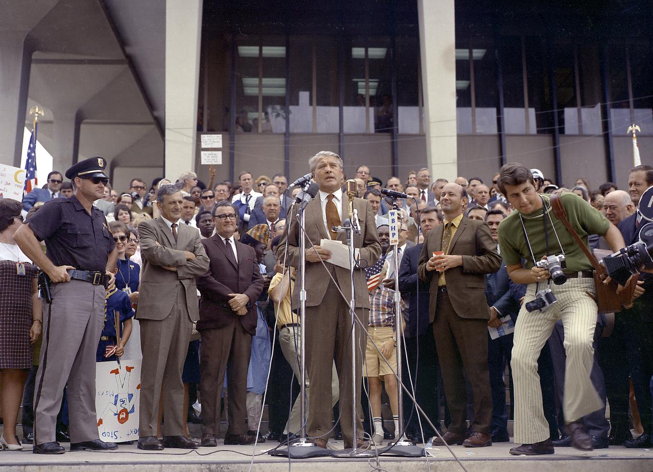 Apollo 11 splashdown celebration in Huntsville, Alabama, on July 24, 1969. Huntsville Alabama is the home of the Marshall Space Flight Center which developed the Saturn vehicles under the direction of Dr. von Braun. The photo shows Dr. von Braun speaking to the crowd at the Madison County Courthouse as Mayor Joe Davis, Madison County Commissioner James Record and City Council President Ken Johnson look on.