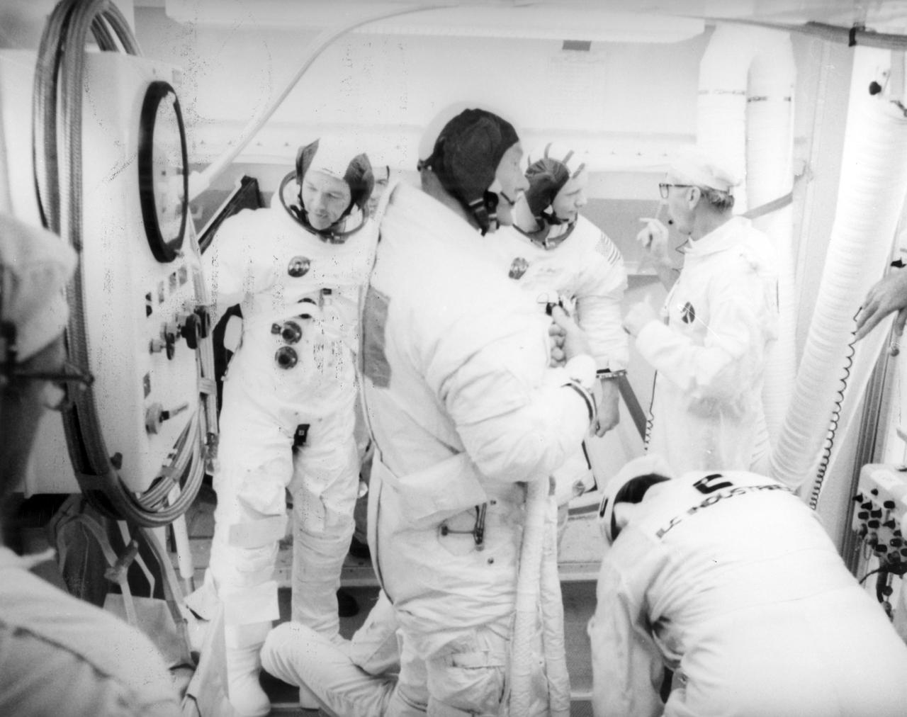 Apollo 11 crew members (left to right) Michael Collins, Edwin Aldrin (foreground), and Neil Armstrong, wearing space suits, leave the Apollo 11 space craft after participation in the countdown demonstration test for the upcoming mission. The Apollo 11 mission, the first lunar landing mission, launched from the Kennedy Space Center (KSC) in Florida via the Marshall Space Flight Center (MSFC) developed Saturn V launch vehicle on July 16, 1969 and safely returned to Earth on July 24, 1969. The CM, “Columbia”, piloted by Collins, remained in a parking orbit around the Moon while the LM, “Eagle’’, carrying astronauts Armstrong and Aldrin, landed on the Moon. On July 20, 1969, Armstrong was the first human to ever stand on the lunar surface, followed Aldrin. During 2½ hours of surface exploration, the crew collected 47 pounds of lunar surface material for analysis back on Earth. With the success of Apollo 11, the national objective to land men on the Moon and return them safely to Earth had been accomplished.  