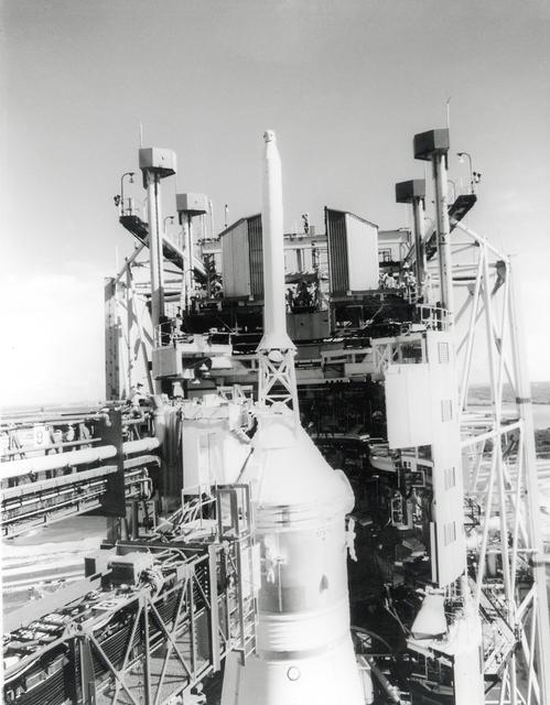 A technician can be seen working atop the white room across from the escape tower of the Apollo 11 spacecraft a few days prior to the launch of the Saturn V moon rocket. The towering 363-foot Saturn V was a multi-stage, multi-engine launch vehicle standing taller than the Statue of Liberty. Altogether, the Saturn V engines produced as much power as 85 Hoover Dams