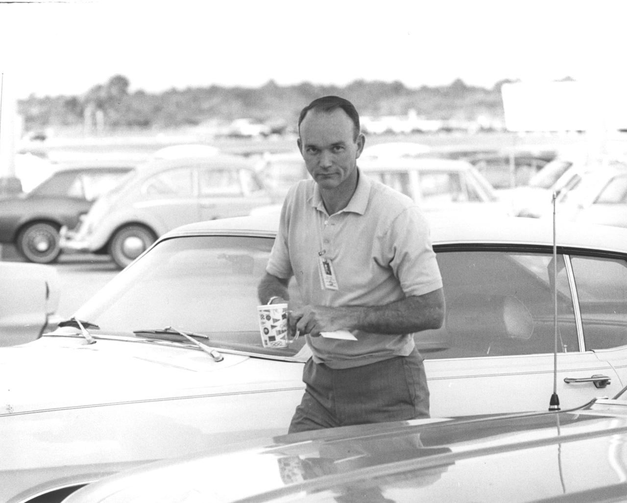 In this photograph, Apollo 11 astronaut Michael Collins carries his coffee with him as he arrives at the flight crew training building of the NASA Kennedy Space Center (KSC) in Florida, one week before the nation’s first lunar landing mission. The Apollo 11 mission launched from KSC via the Marshall Space Flight Center (MSFC) developed Saturn V launch vehicle on July 16, 1969 and safely returned to Earth on July 24, 1969. Aboard the space craft were astronauts Neil A. Armstrong, commander; Michael Collins, Command Module (CM) pilot; and Edwin E. (Buzz) Aldrin Jr., Lunar Module (LM) pilot. The CM, “Columbia”, piloted by Collins, remained in a parking orbit around the Moon while the LM, “Eagle’’, carrying astronauts Armstrong and Aldrin, landed on the Moon. On July 20, 1969, Armstrong was the first human to ever stand on the lunar surface, followed by Aldrin. During 2½ hours of surface exploration, the crew collected 47 pounds of lunar surface material for analysis back on Earth. With the success of Apollo 11, the national objective to land men on the Moon and return them safely to Earth had been accomplished. 