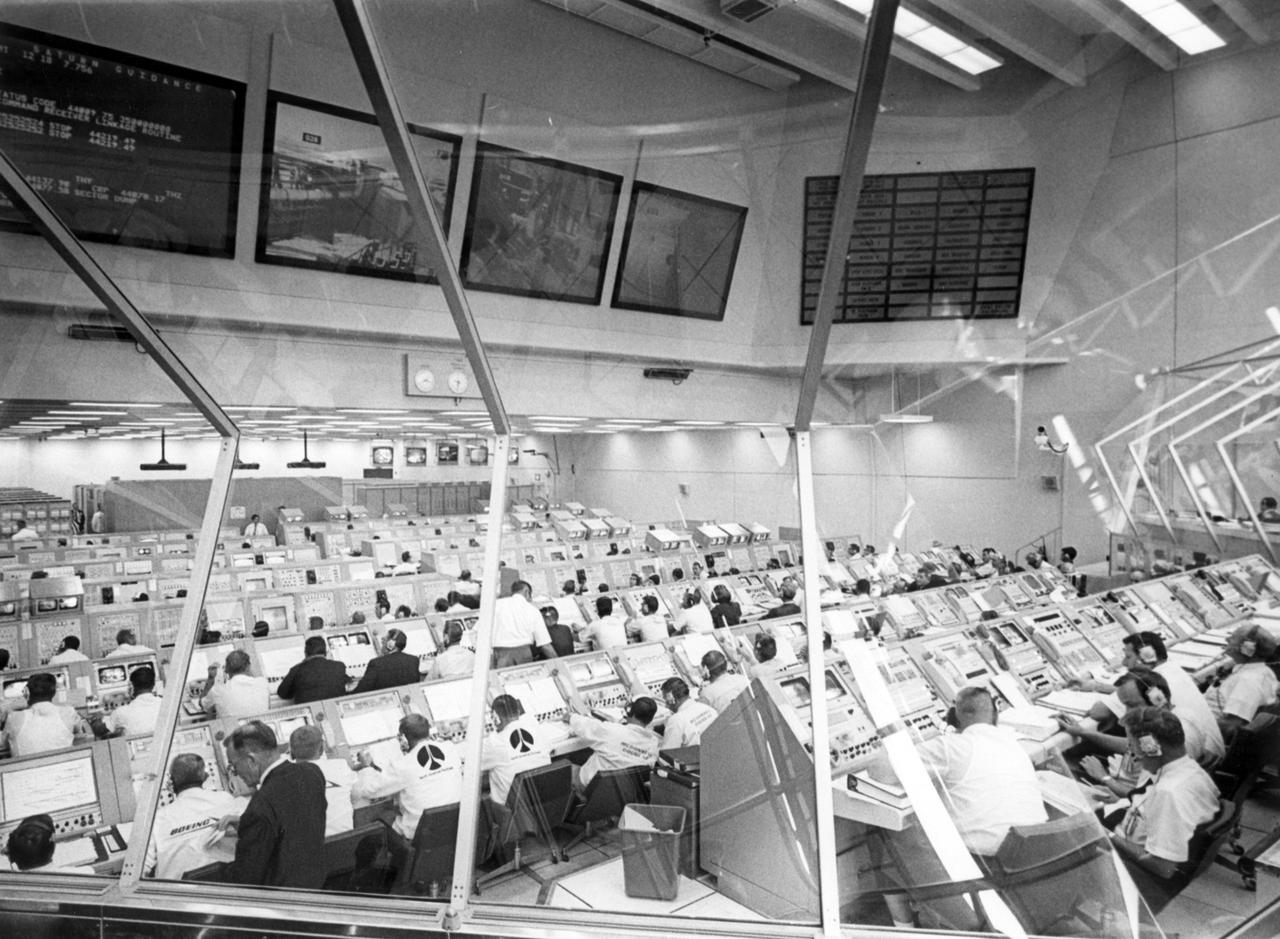 Every console was manned in firing room 1 of the Kennedy Space Flight Center (KSC) control center during the launch countdown for Apollo 11. Apollo 11, the first lunar landing mission, launched from KSC in Florida via the Marshall Space Flight Center (MSFC) developed Saturn V launch vehicle on July 16, 1969 and safely returned to Earth on July 24, 1969. Aboard the space craft were astronauts Neil A. Armstrong, commander; Michael Collins, Command Module (CM) pilot; and Edwin E. (Buzz) Aldrin Jr., Lunar Module (LM) pilot. The CM, “Columbia”, piloted by Collins, remained in a parking orbit around the Moon while the LM, “Eagle’’, carrying astronauts Armstrong and Aldrin, landed on the Moon. On July 20, 1969, Armstrong was the first human to ever stand on the lunar surface, followed by Aldrin.  During 2½ hours of surface exploration, the crew collected 47 pounds of lunar surface material for analysis back on Earth. With the success of Apollo 11, the national objective to land men on the Moon and return them safely to Earth had been accomplished.  