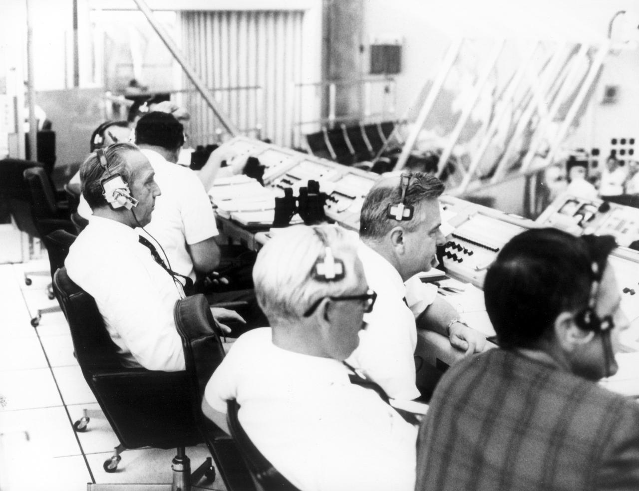 Dr. Kurt Debus, director of the Kennedy Space Flight Center (KSC), participated in the countdown demonstration test for the Apollo 11 mission in firing room 1 of the KSC control center. The Apollo 11 mission, the first lunar landing mission, launched from KSC in Florida via the Marshall Space Flight Center (MSFC) developed Saturn V launch vehicle on July 16, 1969 and safely returned to Earth on July 24, 1969. Aboard the space craft were astronauts Neil A. Armstrong, commander; Michael Collins, Command Module (CM) pilot; and Edwin E. (Buzz) Aldrin Jr., Lunar Module (LM) pilot. The CM, “Columbia”, piloted by Collins, remained in a parking orbit around the Moon while the LM, “Eagle’’, carrying astronauts Armstrong and Aldrin, landed on the Moon. On July 20, 1969, Armstrong was the first human to ever stand on the lunar surface, followed by Aldrin.  During 2½ hours of surface exploration, the crew collected 47 pounds of lunar surface material for analysis back on Earth. With the success of Apollo 11, the national objective to land men on the Moon and return them safely to Earth had been accomplished.  
