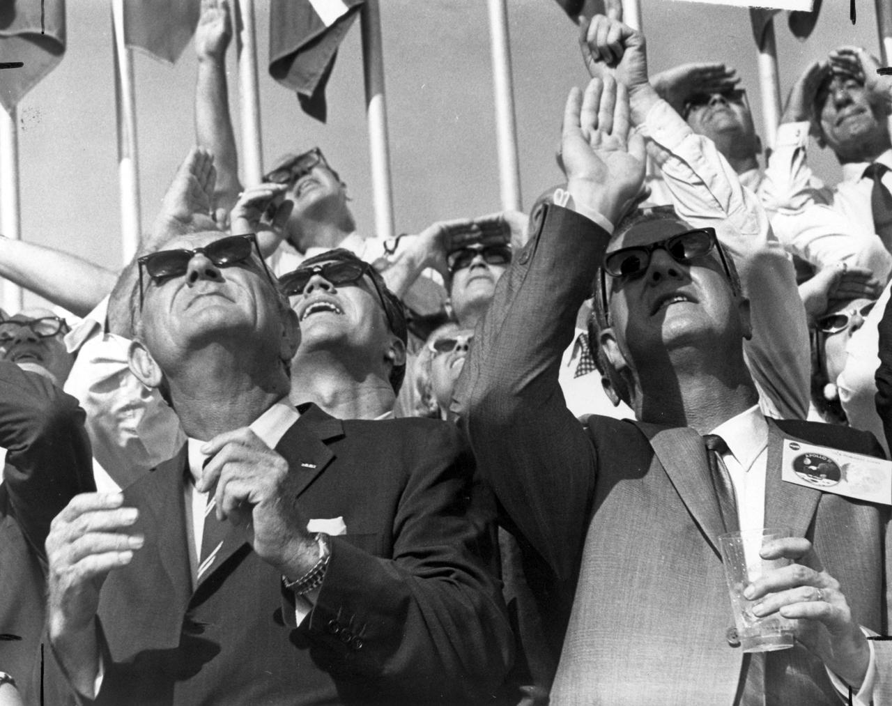 Amidst a crowd of other onlookers, U.S. Vice President Spiro T. Agnew (right) and former U.S. President Lyndon B. Johnson watch the Saturn V vehicle roar skyward carrying the Apollo 11 manned spacecraft into the vast regions of space. On a trajectory to the Moon, the craft lifted off from launch pad 39 at Kennedy Space Flight Center (KSC) on July 16, 1969. The moon bound crew included astronauts Neil A. Armstrong, commander; Michael Collins, Command Module (CM) pilot; and Edwin E. Aldrin Jr., Lunar Module (LM) pilot. The mission finalized with splashdown on July 24, 1969. With the success of Apollo 11, the national objective to land men on the Moon and return them safely to Earth had been accomplished. The Saturn V was developed by the Marshall Space Flight Center (MSFC) under the direction of Werher von Braun.