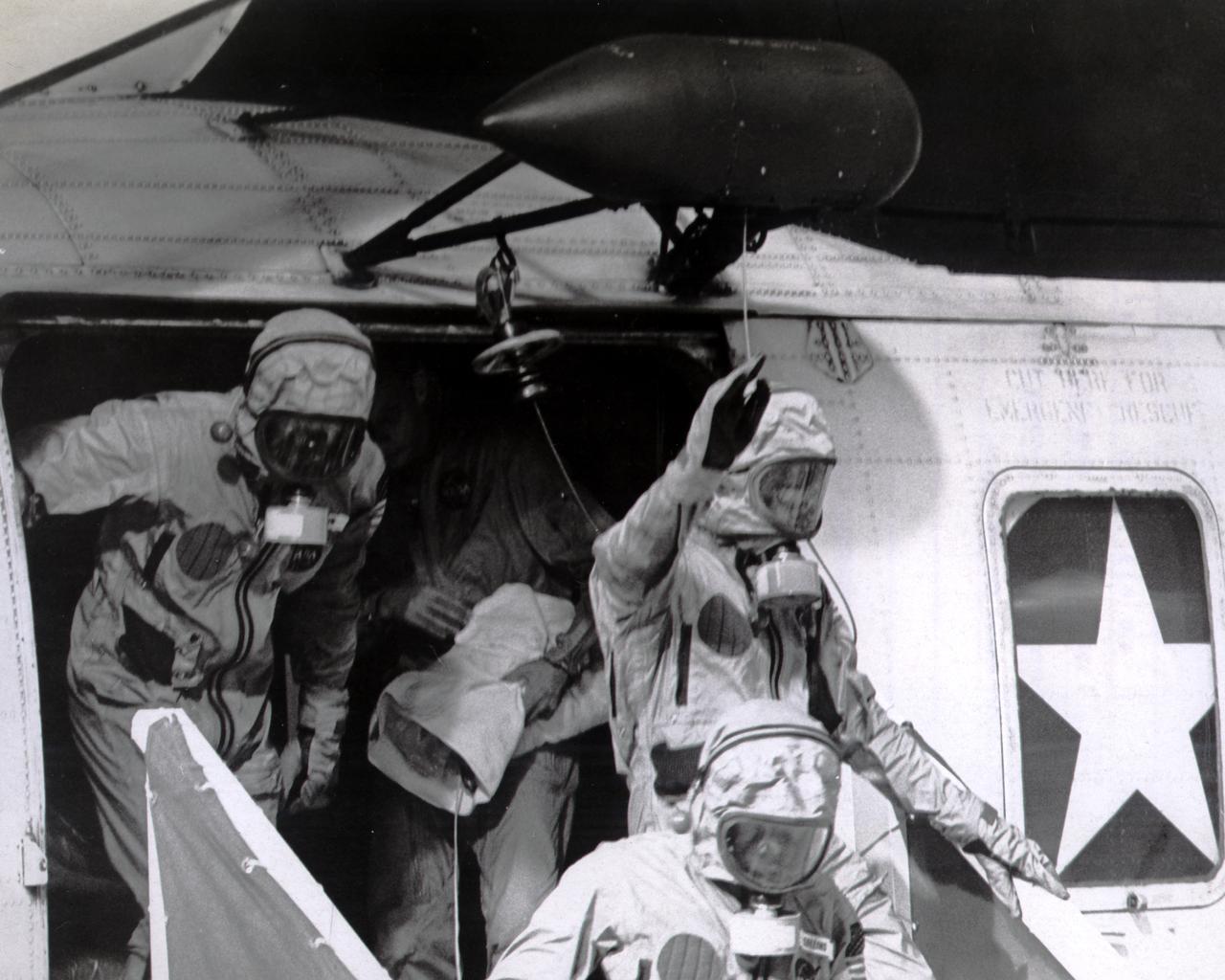 Donned in biological isolation garments, the Apollo 11 crew members, (L-R) Edwin Aldrin, Neil Armstrong (waving), and Michael Collins exit the recovery pick up helicopter to board the U.S.S. Hornet aircraft carrier after splashdown. The recovery operation took place in the Pacific Ocean where Navy para-rescue men recovered the capsule housing the 3-man Apollo 11 crew. The crew was airlifted to safety aboard the U.S.S. Hornet, where they were quartered in a Mobile Quarantine Facility (MQF). This portable facility served as their home until they reached the NASA Manned Spacecraft Center (MSC) Lunar Receiving Laboratory in Houston, Texas. The Apollo 11 mission, the first manned lunar mission, launched from the Kennedy Space Center (KSC), Florida via the Saturn V launch vehicle on July 16, 1969 and safely returned to Earth on July 24, 1969. Aboard were Neil A. Armstrong, commander; Michael Collins, Command Module (CM) pilot; and Edwin E. Aldrin Jr., Lunar Module (LM) pilot. The CM, piloted by Michael Collins remained in a parking orbit around the Moon while the LM, named “Eagle’’, carrying astronauts Neil Armstrong and Edwin Aldrin, landed on the Moon. Armstrong was the first human to ever stand on the lunar surface, followed by Aldrin. During 2½ hours of surface exploration, the crew collected 47 pounds of lunar surface material for analysis back on Earth. With the success of Apollo 11, the national objective to land men on the Moon and return them safely to Earth had been accomplished. The Saturn V vehicle was developed by the Marshall Space Flight Center (MSFC) under the direction of Dr. Werher von Braun.                                            