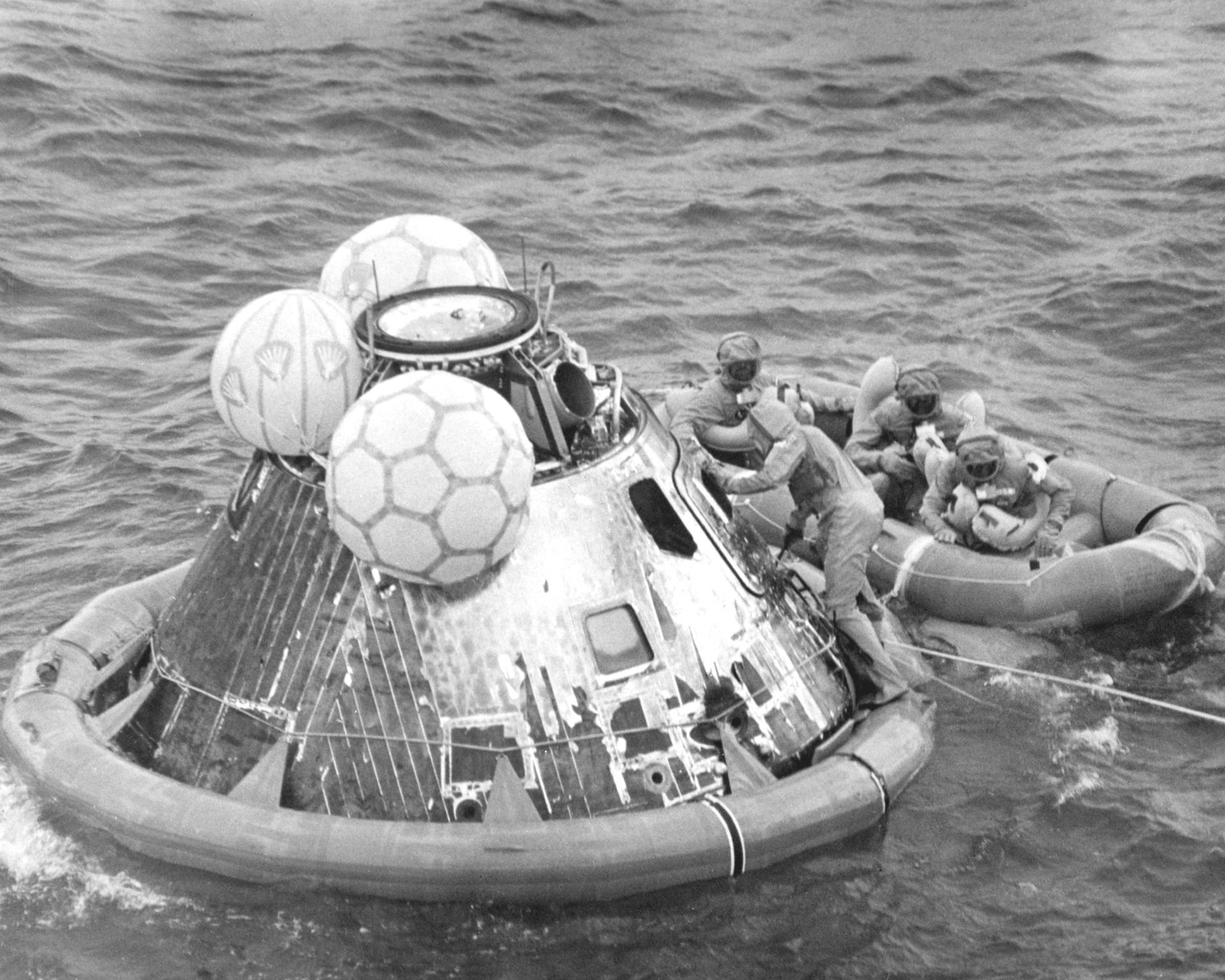 The Apollo 11 command module floats in the Pacific Ocean after splashdown