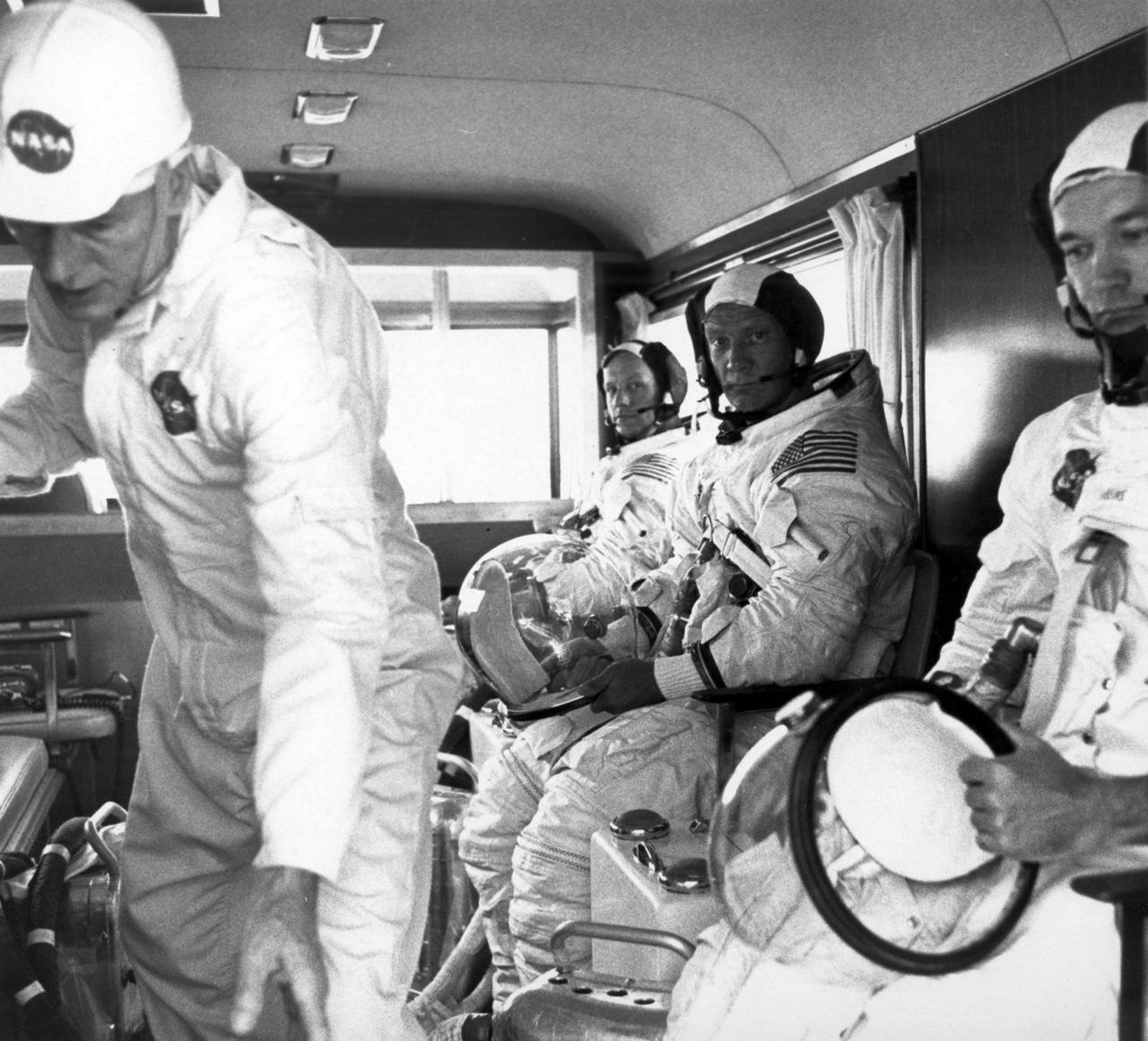 Apollo 11 crew members (rear to front) Neil Armstrong, Edwin Aldrin, and Michael Collins, wearing space suits, ride the van to the launch pad to participate in the countdown demonstration test for the upcoming Apollo 11 mission. The Apollo 11 mission, the first lunar landing mission, launched from the Kennedy Space Center (KSC) in Florida via the Marshall Space Flight Center (MSFC) developed Saturn V launch vehicle on July 16, 1969 and safely returned to Earth on July 24, 1969. Aboard the space craft were astronauts Neil A. Armstrong, commander; Michael Collins, Command Module (CM) pilot; and Edwin E. (Buzz) Aldrin Jr., Lunar Module (LM) pilot. The CM, “Columbia”, piloted by Collins, remained in a parking orbit around the Moon while the LM, “Eagle’’, carrying astronauts Armstrong and Aldrin, landed on the Moon. On July 20, 1969, Armstrong was the first human to ever stand on the lunar surface, followed by Aldrin. During 2½ hours of surface exploration, the crew collected 47 pounds of lunar surface material for analysis back on Earth. With the success of Apollo 11, the national objective to land men on the Moon and return them safely to Earth had been accomplished.  