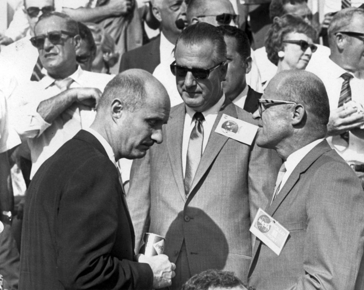 Apollo 10 commander, Thomas P. Stafford (left) and Kennedy Space Center (KSC) Deputy Director Albert Siepert (right) talk with U.S. Vice President Spiro T. Agnew a few minutes before the launch of Apollo 11. The Apollo 11 mission, the first manned lunar mission, launched from KSC, Florida via the Saturn V launch vehicle on July 16, 1969 and safely returned to Earth on July 24, 1969. The Saturn V vehicle was developed by the Marshall Space Flight Center (MSFC) under the direction of Dr. Wernher von Braun. Aboard the space craft were astronauts Neil A. Armstrong, commander; Michael Collins, Command Module (CM) pilot; and Edwin E. Aldrin Jr., Lunar Module (LM) pilot. The CM, piloted by Michael Collins remained in a parking orbit around the Moon while the LM, named “Eagle’’, carrying astronauts Neil Armstrong and Edwin Aldrin, landed on the Moon. Armstrong was the first human to ever stand on the lunar surface, followed by Edwin (Buzz) Aldrin.  During 2½ hours of surface exploration, the crew collected 47 pounds of lunar surface material for analysis back on Earth. With the success of Apollo 11, the national objective to land men on the Moon and return them safely to Earth had been accomplished.                                        