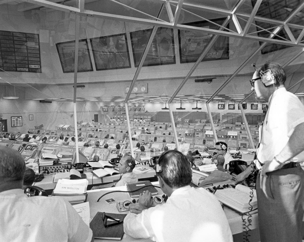 From the Kennedy Space Flight Center (KSC) control room, Apollo Program Director Lieutenant General Samuel C. Phillips monitors pre-launch activities for Apollo 11. The Apollo 11 mission, the first lunar landing mission, launched from the KSC in Florida via the Marshall Space Flight Center (MSFC) developed Saturn V launch vehicle on July 16, 1969 and safely returned to Earth on July 24, 1969. Aboard the space craft were astronauts Neil A. Armstrong, commander; Michael Collins, Command Module (CM) pilot; and Edwin E. (Buzz) Aldrin Jr., Lunar Module (LM) pilot. The CM, “Columbia”, piloted by Collins, remained in a parking orbit around the Moon while the LM, “Eagle’’, carrying astronauts Armstrong and Aldrin, landed on the Moon. On July 20, 1969, Armstrong was the first human to ever stand on the lunar surface, followed by Aldrin. During 2½ hours of surface exploration, the crew collected 47 pounds of lunar surface material for analysis back on Earth. With the success of Apollo 11, the national objective to land men on the Moon and return them safely to Earth had been accomplished.  