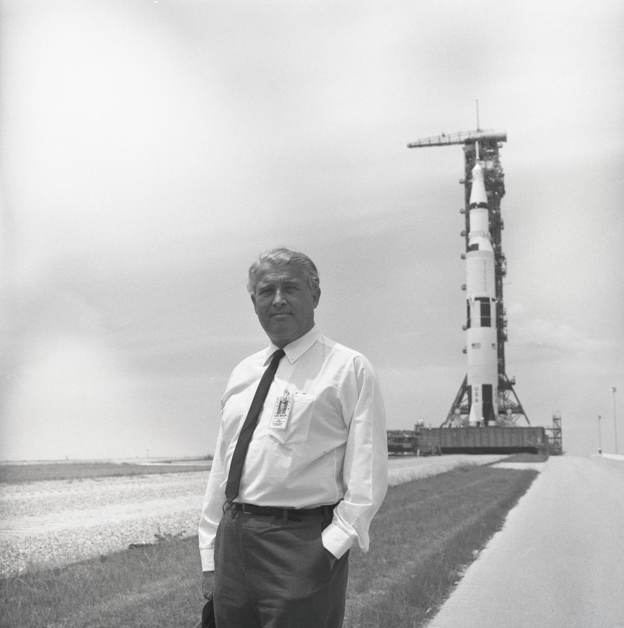 Dr. von Braun pauses in front of the Saturn V vehicle being readied for the historic Apollo 11 lunar landing mission at the Kennedy Space Center (KSC). The Saturn V vehicle was developed by the Marshall Space Flight Center (MSFC) under the direction of Dr. von Braun.