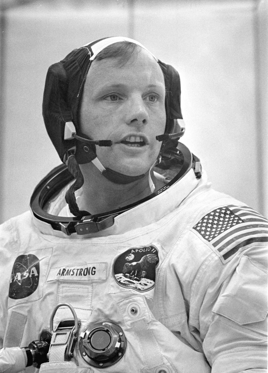 Dunned in his space suit, mission commander Neil A. Armstrong does a final check of his communications system before before the boarding of the Apollo 11 mission. Launched via a Saturn V launch vehicle, the first manned lunar mission launched from the Kennedy Space Center, Florida on July 16, 1969 and safely returned to Earth on July 24, 1969. The Saturn V vehicle was developed by the Marshall Space Flight Center (MSFC) under the direction of Dr. Wernher von Braun. The 3-man crew aboard the flight consisted of astronauts Armstrong; Michael Collins, Command Module (CM) pilot; and Edwin E. Aldrin, Jr., Lunar Module (LM) Pilot.  Armstrong was the first human to ever stand on the lunar surface, followed by Edwin (Buzz) Aldrin. Meanwhile, astronaut Collins piloted the CM in a parking orbit around the Moon. During a 2½ hour surface exploration, the crew collected 47 pounds of lunar surface material which was returned to Earth for analysis. With the success of Apollo 11, the national objective to land men on the Moon and return them safely to Earth had been accomplished. 