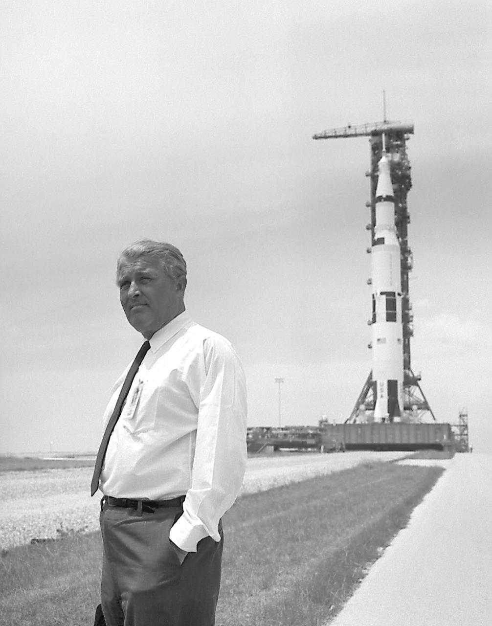 Dr. von Braun pauses in front of the Saturn V vehicle being readied for the historic Apollo 11 lunar landing mission at the Kennedy Space Center (KSC). The Saturn V vehicle was developed by the Marshall Space Flight Center (MSFC) under the direction of Dr. von Braun.