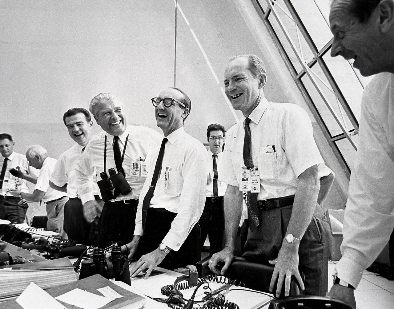 NASA officials, (left to right) Charles W. Mathews; Dr. Wernher von Braun, Director, Marshall Space Flight Center (MSFC); Dr. George E. Mueller, Associate Administrator for Marned Space Flight; and Air Force Lt. General Samuel C. Phillips, Apollo Program Director celebrate the successful launch of Apollo 11 in the control room at Kennedy Space Center (KSC) on July 16, 1969. Boosted by the Saturn V launch vehicle, the Apollo 11 mission with a crew of three: Astronauts Neil A. Armstrong, Michael Collins, and Edwin E. Aldrin, made the first manned lunar landing. The Saturn V vehicle was developed by Marshall Space Flight Center (MSFC) under the direction of Dr. von Braun. 