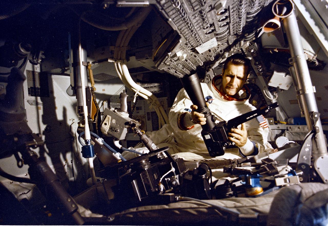This is a view of astronaut Richard F. Gordon attaching a high resolution telephoto lens to a camera aboard the Apollo 12 Command Module (CM) Yankee Clipper. The second manned lunar landing mission, Apollo 12 launched from launch pad 39-A at Kennedy Space Center in Florida on November 14, 1969 via a Saturn V launch vehicle. The Saturn V vehicle was developed by the Marshall Space Flight Center (MSFC) under the direction of Dr. Wernher von Braun. Aboard Apollo 12 was a crew of three astronauts:  Alan L. Bean, pilot of the Lunar Module (LM), Intrepid; Richard Gordon, pilot of the Command Module (CM), Yankee Clipper; and Spacecraft Commander Charles Conrad. The LM, Intrepid, landed astronauts Conrad and Bean on the lunar surface in what’s known as the Ocean of Storms. Their lunar soil activities included the deployment of the Apollo Lunar Surface Experiments Package (ALSEP), finding the unmanned Surveyor 3 that landed on the Moon on April 19, 1967, and collecting 75 pounds (34 kilograms) of rock samples. Astronaut Richard Gordon piloted the CM, Yankee Clipper, in a parking orbit around the Moon. Apollo 12 safely returned to Earth on November 24, 1969.
