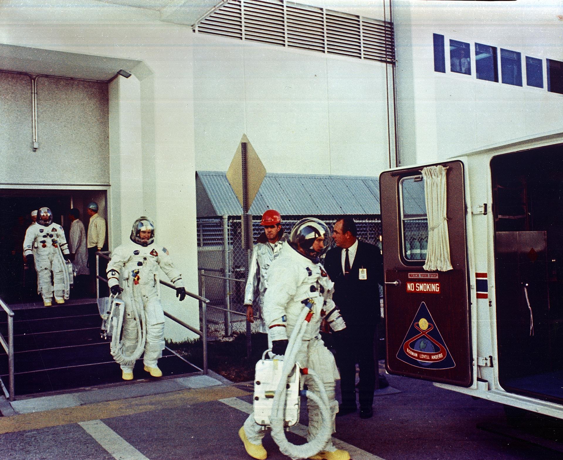 The Apollo 8 astronauts walk to the transfer van prior to their launch