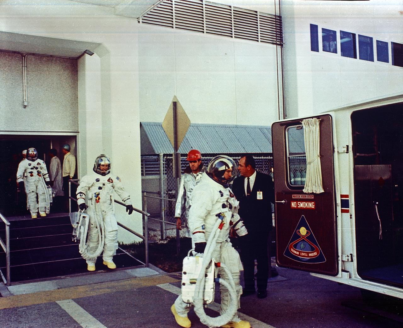 Apollo 8 Astronauts William Anders, Lunar Module (LM) Pilot; James Lovell, Command Module (CM) pilot; and Frank Borman, commander, transfer to the astronaut van for the trip to the launch pad. The first manned Apollo mission launched aboard the Saturn V and first manned Apollo craft to enter lunar orbit, the SA-503, Apollo 8 mission liftoff occurred on December 21, 1968 and returned safely to Earth on December 27, 1968. The mission achieved operational experience and tested the Apollo command module systems, including communications, tracking, and life-support, in cis-lunar space and lunar orbit, and allowed evaluation of crew performance on a lunar orbiting mission. The crew photographed the lunar surface, both far side and near side, obtaining information on topography and landmarks as well as other scientific information necessary for future Apollo landings. All systems operated within allowable parameters and all objectives of the mission were achieved.