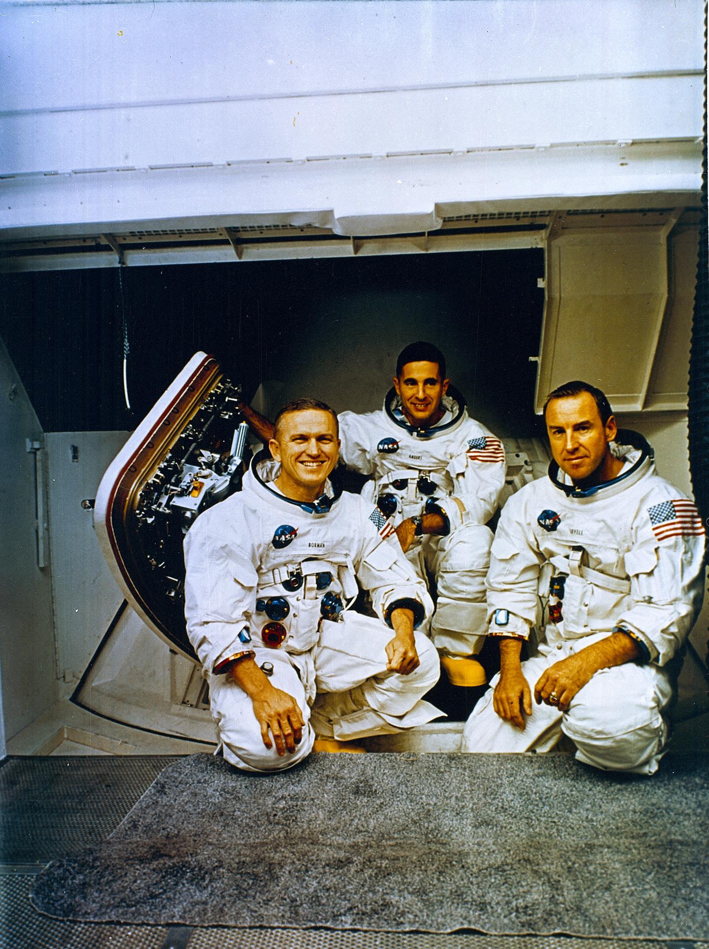 The Apollo 8 crew pose for a photo wearing their space suits