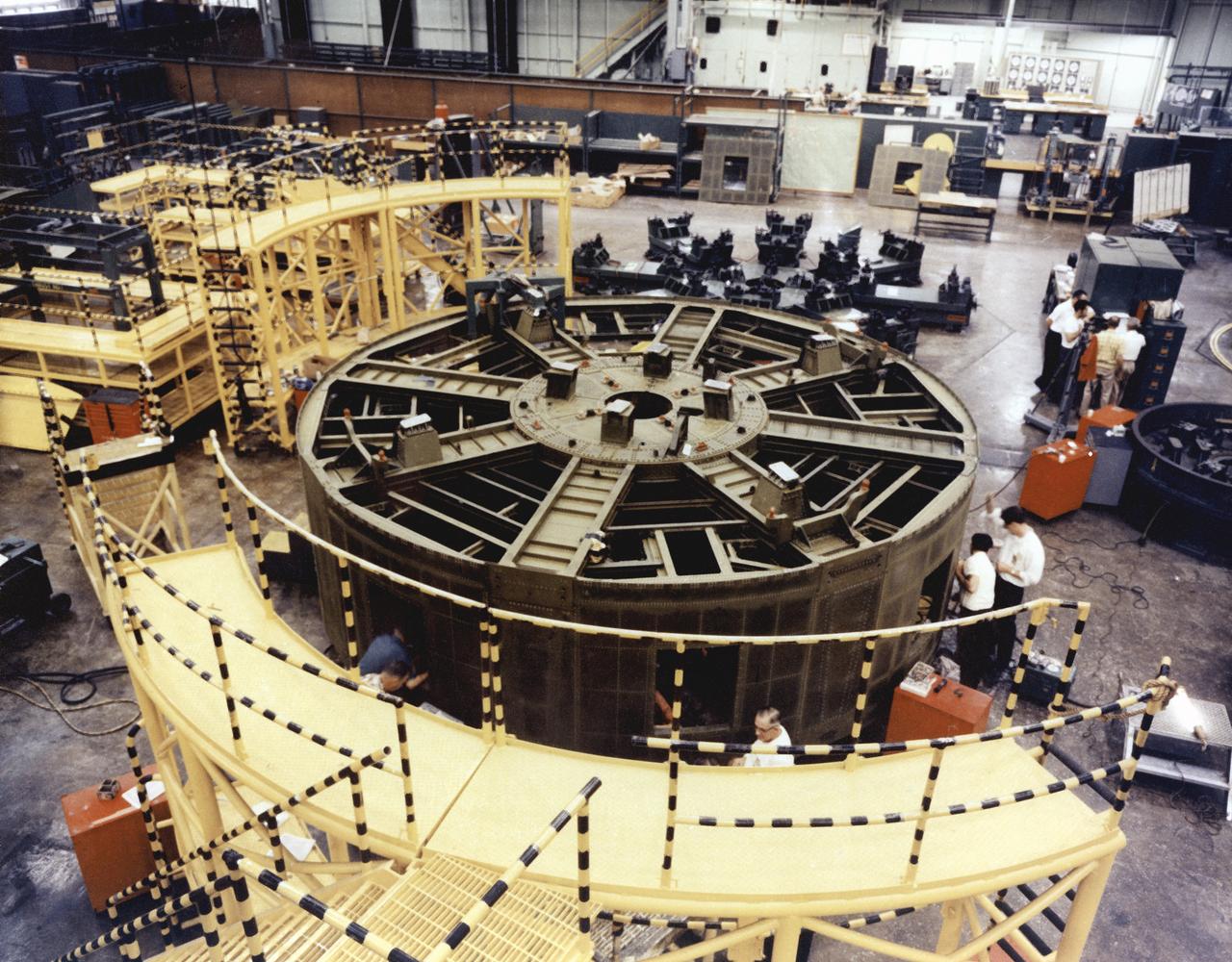 In one of the initial assembly steps for the Saturn IB launch vehicle's S-IB (first) stage, workers at the Michoud Assembly Facility (MAF) near New Orleans, Louisiana, complete the thrust structure. Developed by the Marshall Space Flight Center and built by the Chrysler Corporation at Michoud Assembly Facility (MAF), the S-IB utilized eight H-1 engines and each produced 200,000 pounds of thrust, a combined thrust of 1,600,000 pounds.