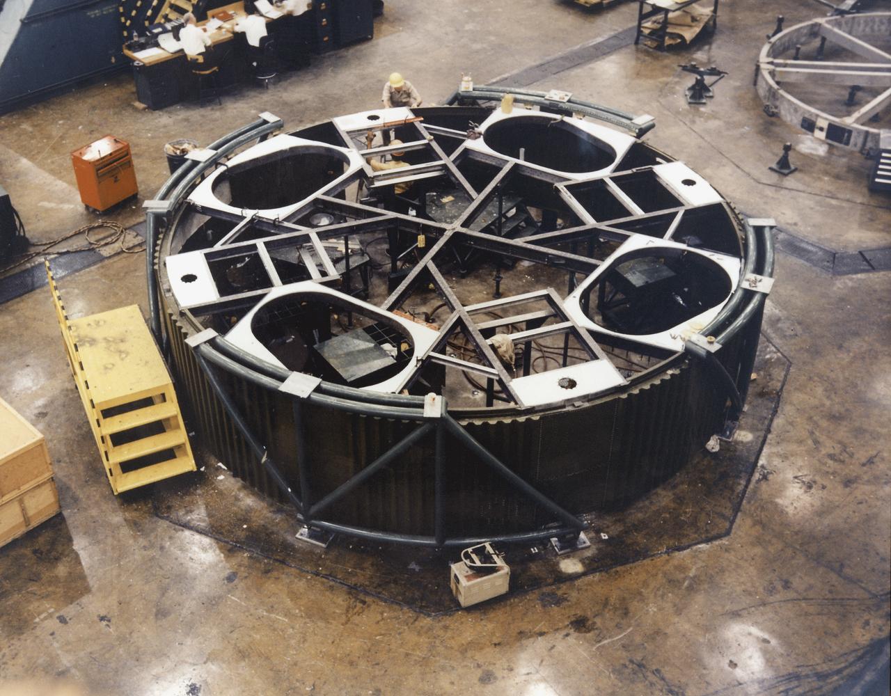 In one of the initial assembly steps for the Saturn IB launch vehicle's S-IB (first) stage, workers at the Michoud Assembly Facility (MAF) near New Orleans, Louisiana, complete the lower shroud assembly. Developed by the Marshall Space Flight Center and built by the Chrysler Corporation at Michoud Assembly Facility (MAF), the S-IB utilized the eight H-1 engines and each produced 200,000 pounds of thrust, a combined thrust of 1,600,000 pounds.