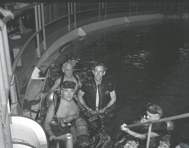 Dr. E. Stuhlinger, Dr. W. von Braun, and Dr. J. Piccard, along with others, take a swim in the Neutral Buoyancy Simulator (NBS) at the Marshall Space Flight Center. The NBS was instrumental in providing a zero-gravity environment where astronauts could practice tasks assigned for up coming space flights.