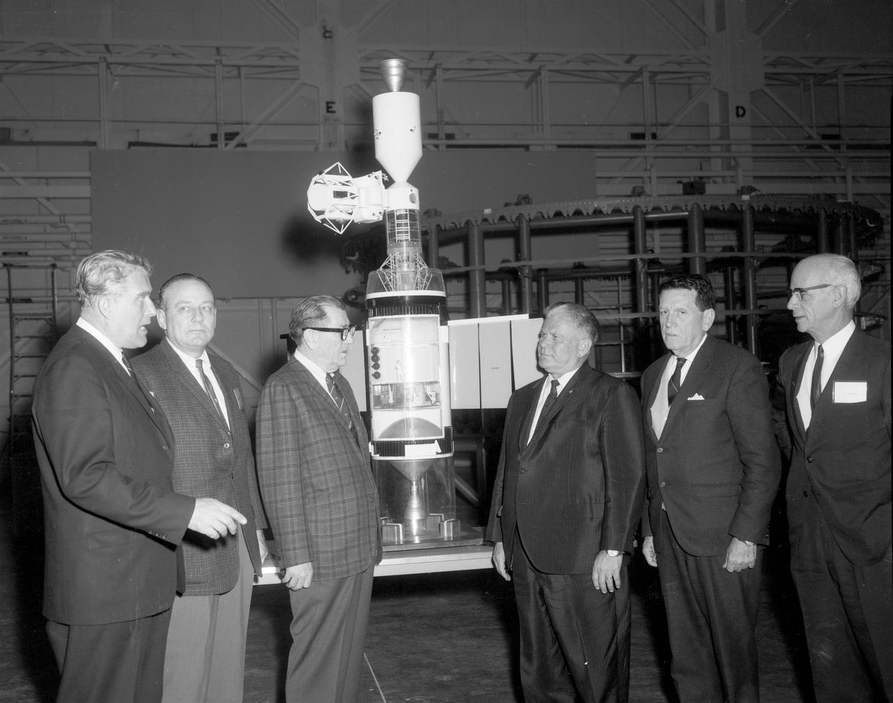 The members of the House Committee on Science and Astronautics visited the Marshall Space Flight Center (MSFC) on March 9, 1962 to gather firsthand information of the nation’s space exploration program. The congressional group was composed of members of the Subcommittee on Manned Space Flight. Standing at the Apollo Applications Program Cluster Model in building 4745 are (left-to-right): Dr. Wernher von Braun, MSFC; Congressman Joe D. Waggoner, Democratic representative of Louisiana; Congressman Earle Cabell, Democratic representative of Texas; Subcommittee Chairman Olin E. Teague, Democratic representative of Texas; Congressman James G. Fulton, Republican representative of Pennsylvania; and Dr. Ernst Stuhlinger, associate MSFC director for science. The subcommittee was briefed on MSFC’s manned space efforts earlier in the day and then inspected mockups of the Saturn I Workshop and the Apollo Telescope Mount, two projects developed by MSFC for the post-Apollo program.