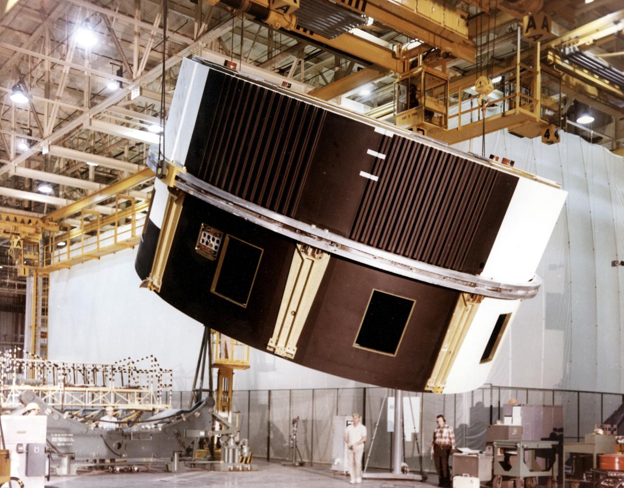 Workers at the Michoud Assembly Facility (MAF) near New Orleans, Louisiana, hoist the thrust structure assembly for the Saturn IB S-IB (first) stage. Developed by the Marshall Space Flight Center and built by the Chrysler Corporation at Michoud Assembly Facility (MAF), the S-IB utilized eight H-1 engines and each produced 200,000 pounds of thrust, a combined thrust of 1,600,000 pounds.