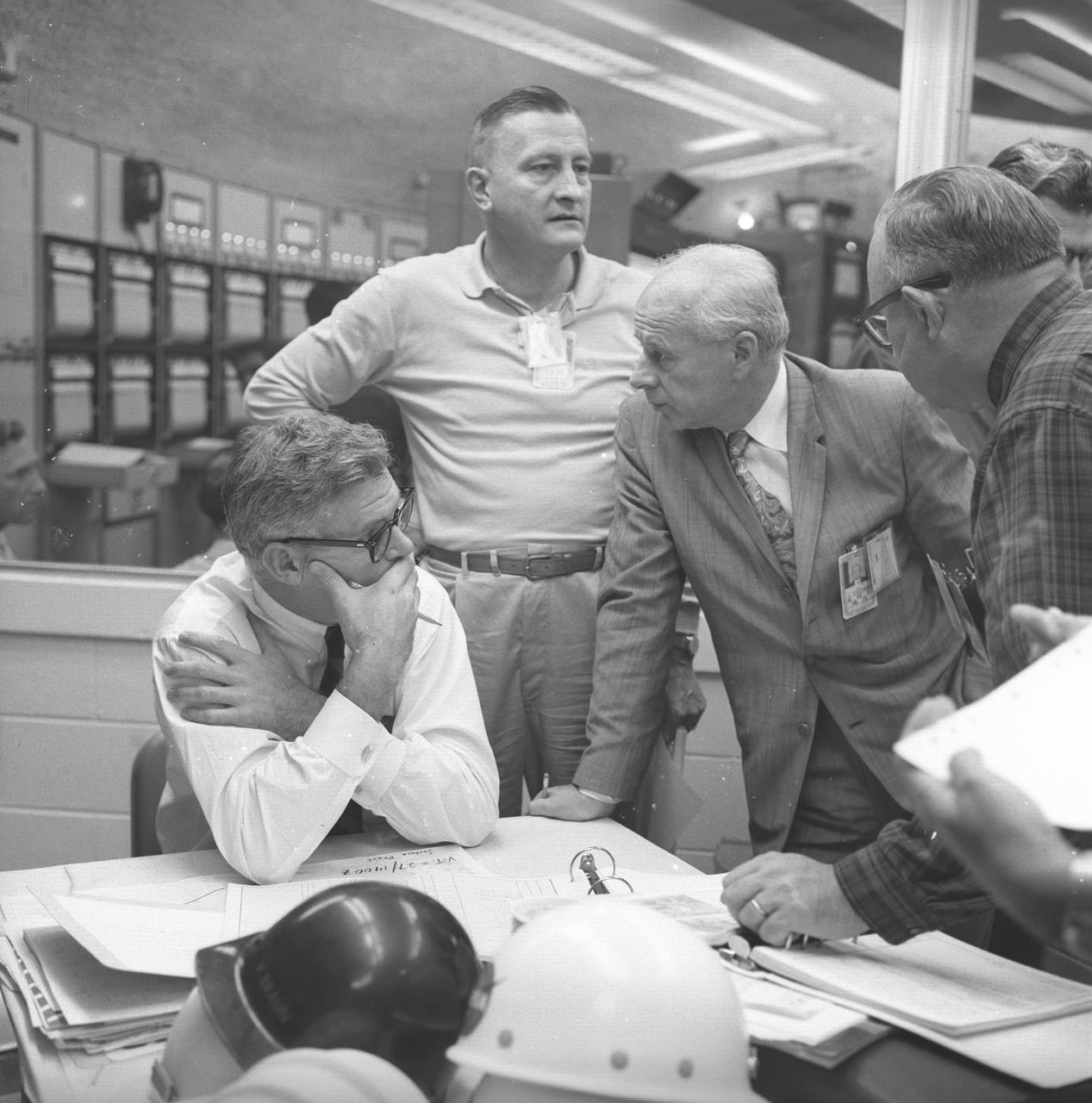 Dr. Eberhard Rees surrounded by other rocket scientist in the blockhouse, a safe viewing area for rocket tests or launches, during a missile launch. Dr. Rees, Marshall's second Center Director (1970-1973), kept most of Von Braun's plans alive but also succeeded in bringing the Saturn program to forebearance.
