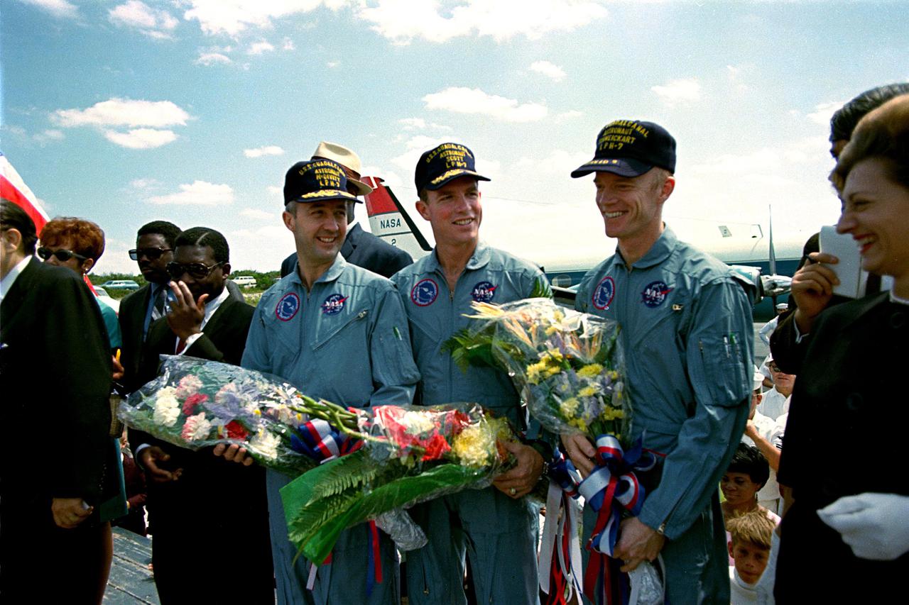 KENNEDY SPACE CENTER, FLA. - The Apollo 9 astronauts, left to right, James R. McDivitt, David R. Scott, and Russell L. Schweickart, receive flowers during a brief stopover on this Bahamian island while enroute back to Cape Kennedy.  The three astronauts were launched from Cape Kennedy on March 3 from Launch Pad 39A and spent 10days in Earth orbit to test the Lunar Module Spacecraft in preparation for the upcoming manned lunar landings.  Following their splashdown yesterday about 780 nautical miles southeast of Cape Kennedy, the three astronauts and their spacecraft were picked up by the USS Guadalcanal.