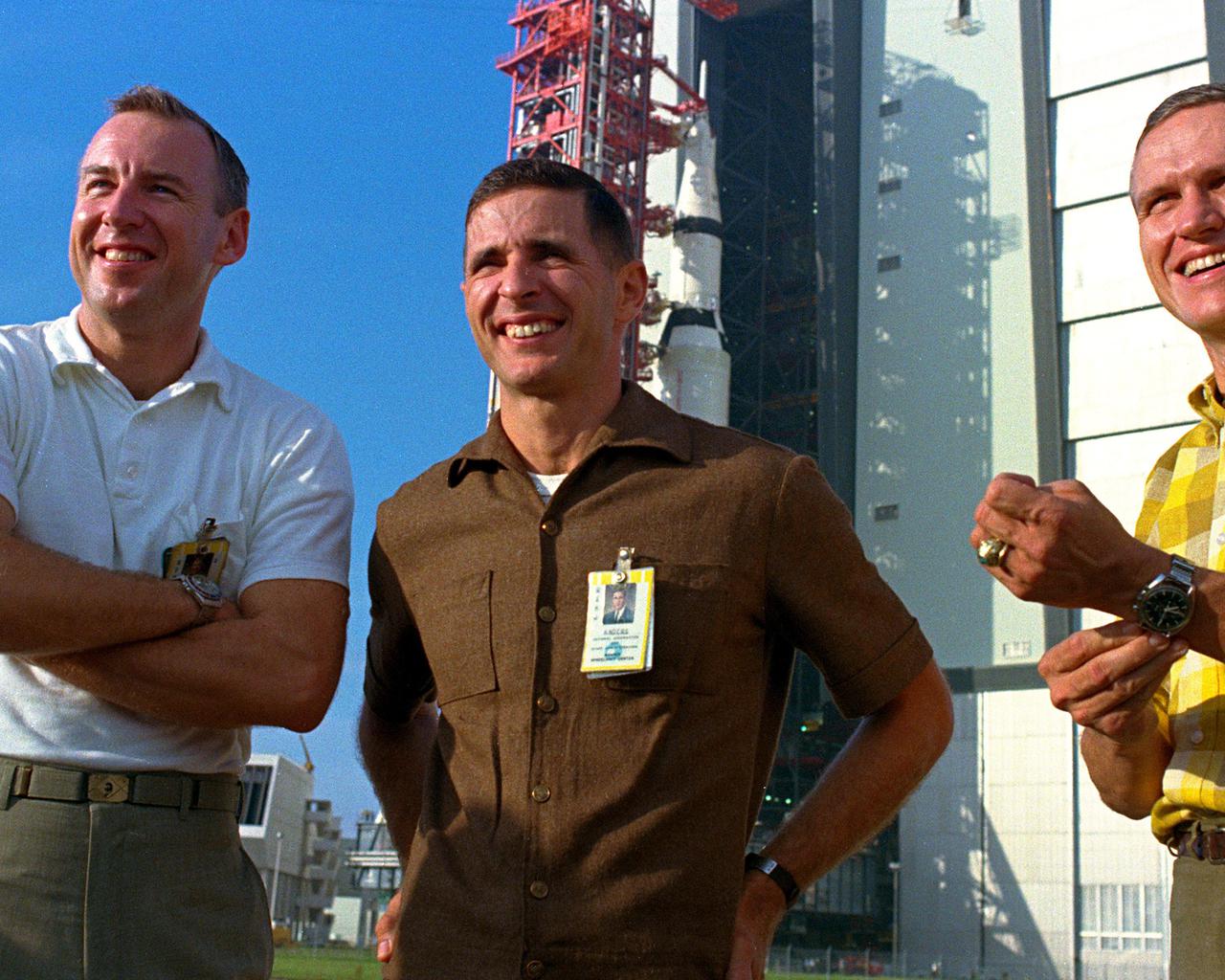 KENNEDY SPACE CENTER, FLA. - The 363-foot-high Apollo Saturn V space vehicle dwarfs the  Apollo 8 Astronauts Frank Borman, James Lovell, and William Anders, during the roll out today of the space vehicle from the  Vehicle Assembly Building (VAB) to Launch Pad 39A. .